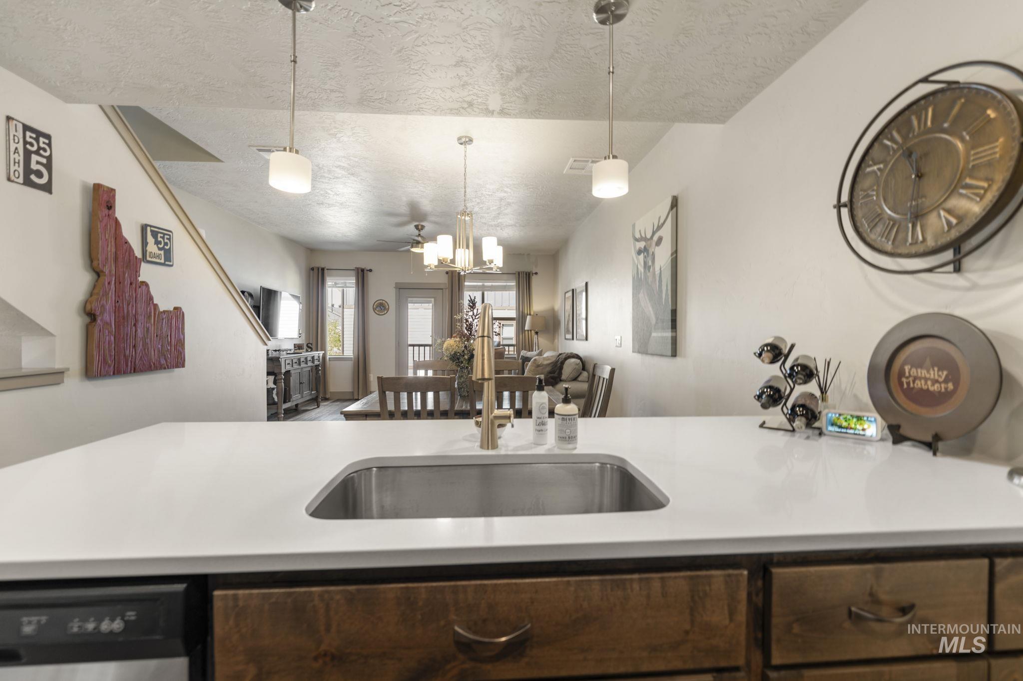 Kitchen island with a stainless steel undermount sink and a gold-finish gooseneck faucet