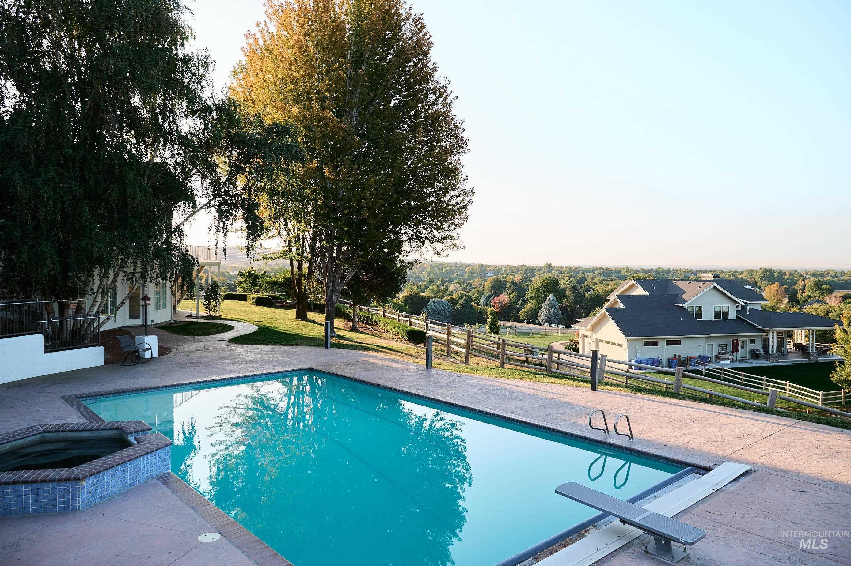 View of swimming pool featuring a patio area and a pool with connected hot tub