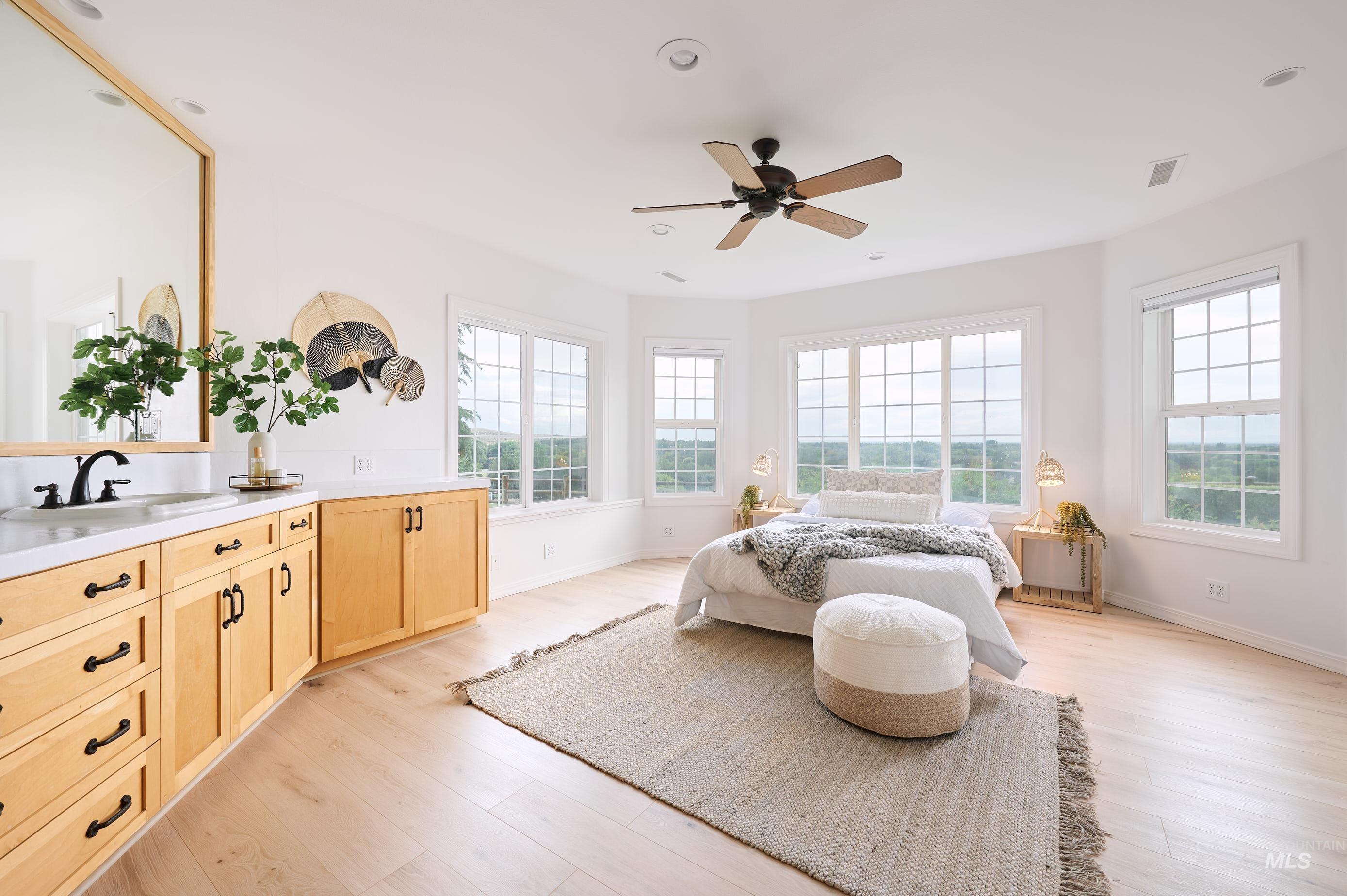 Bedroom featuring light wood finished floors, a ceiling fan, and recessed lighting