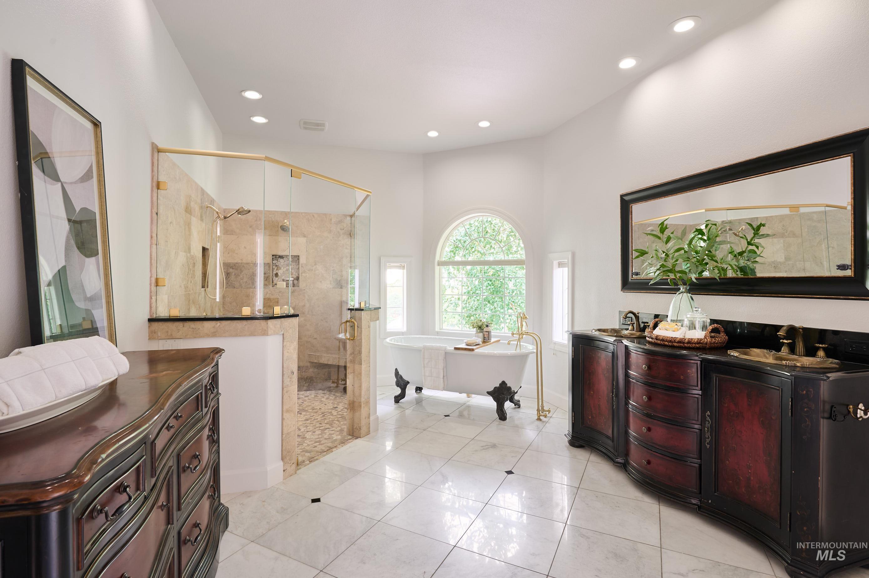 Full bath with a soaking tub, a stall shower, vanity, light tile patterned floors, and recessed lighting
