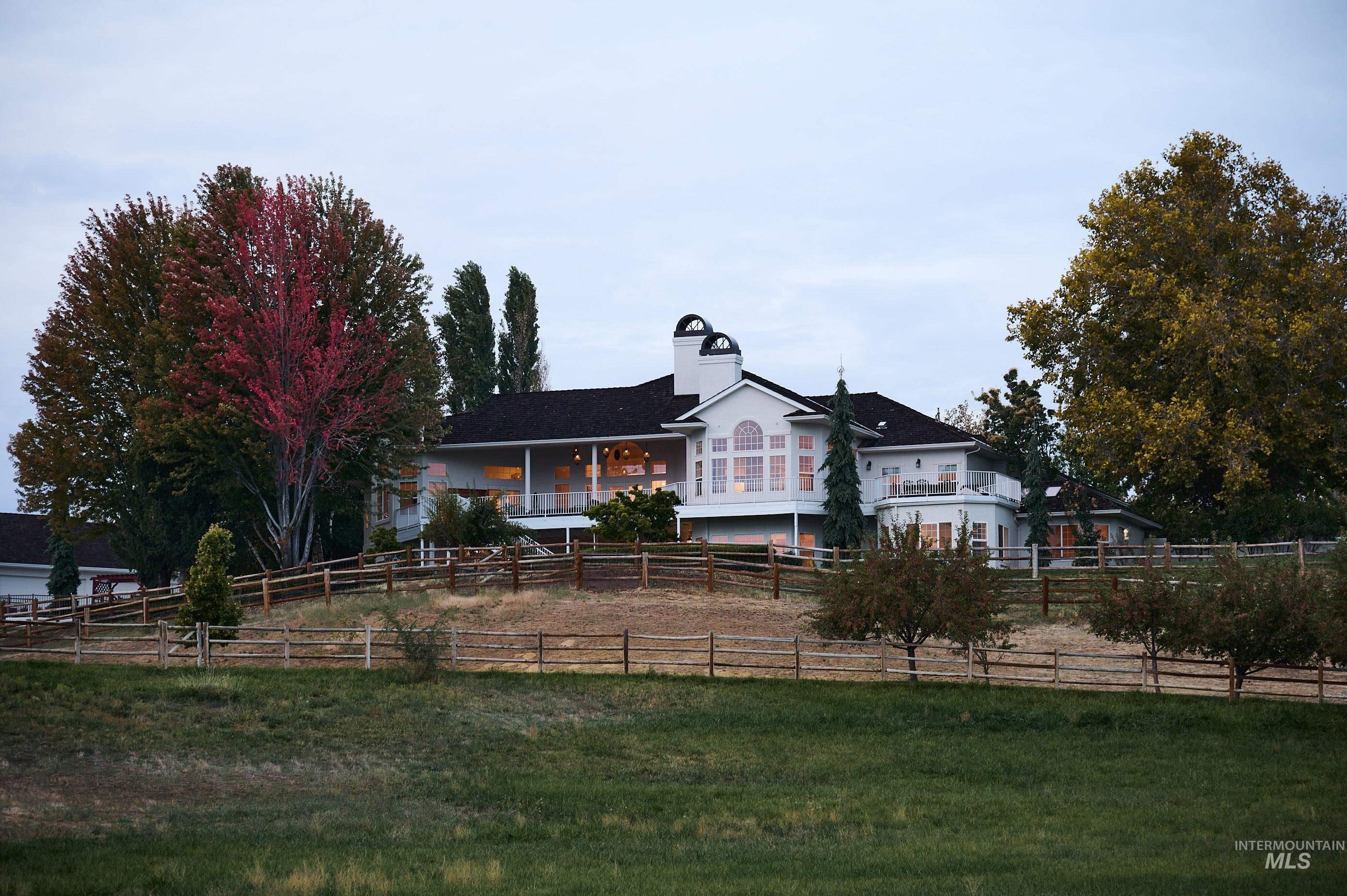 View of front of house featuring a fenced backyard, a chimney, and a porch