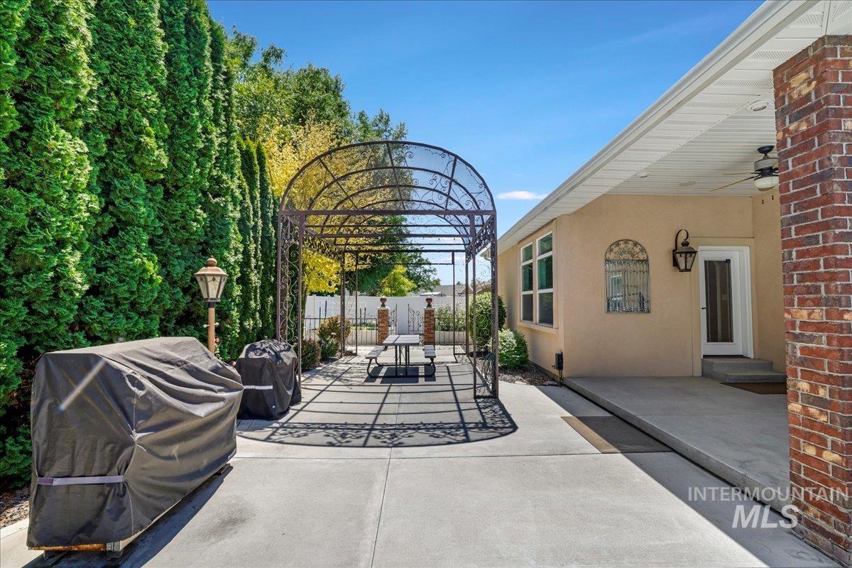 View of patio featuring a grill and ceiling fan