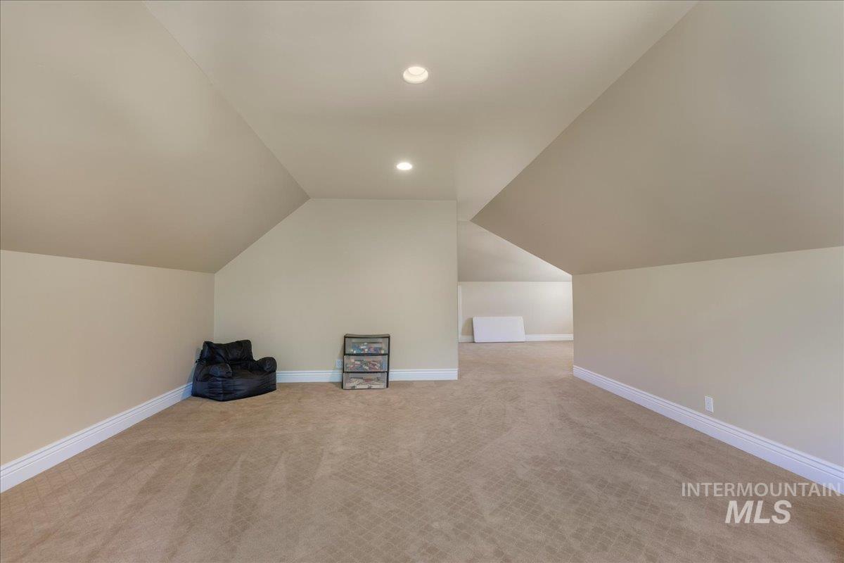 Bonus room featuring lofted ceiling, recessed lighting, and carpet floors