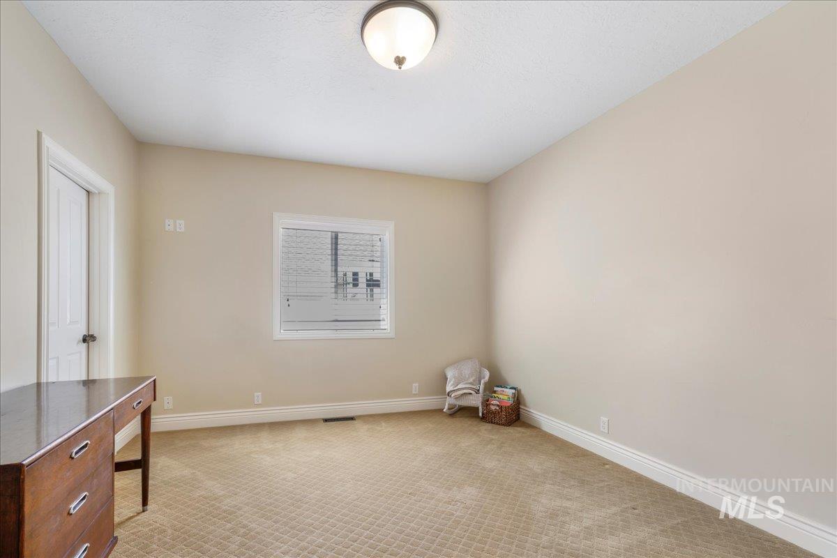 Unfurnished room with light colored carpet and baseboards