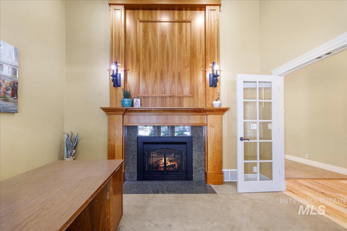 Living room featuring a tile fireplace and carpet floors