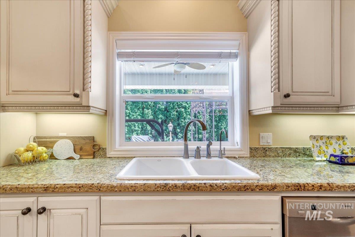 Kitchen featuring stainless steel dishwasher and a sink