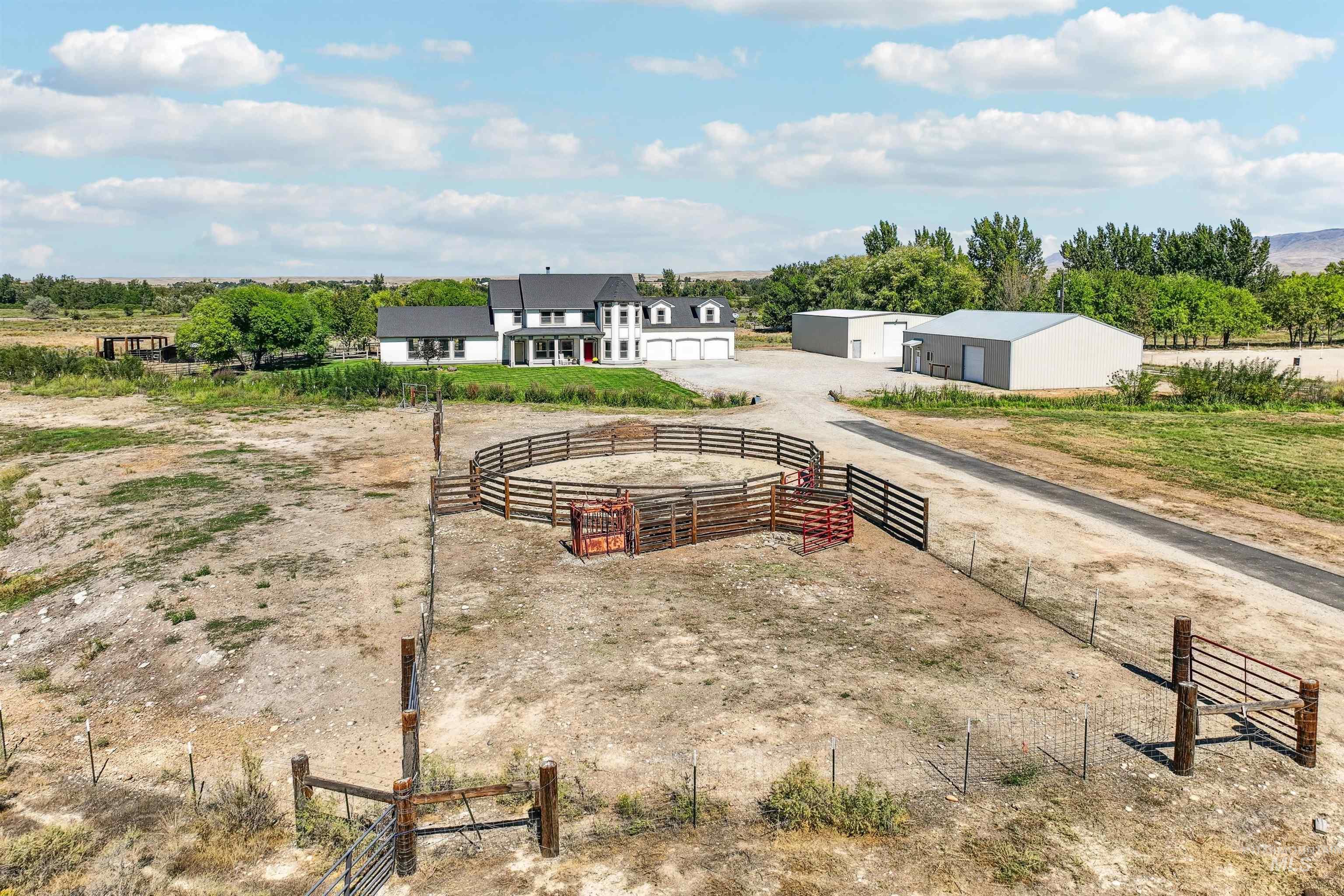 View of yard featuring an outbuilding, a view of countryside, and a garage
