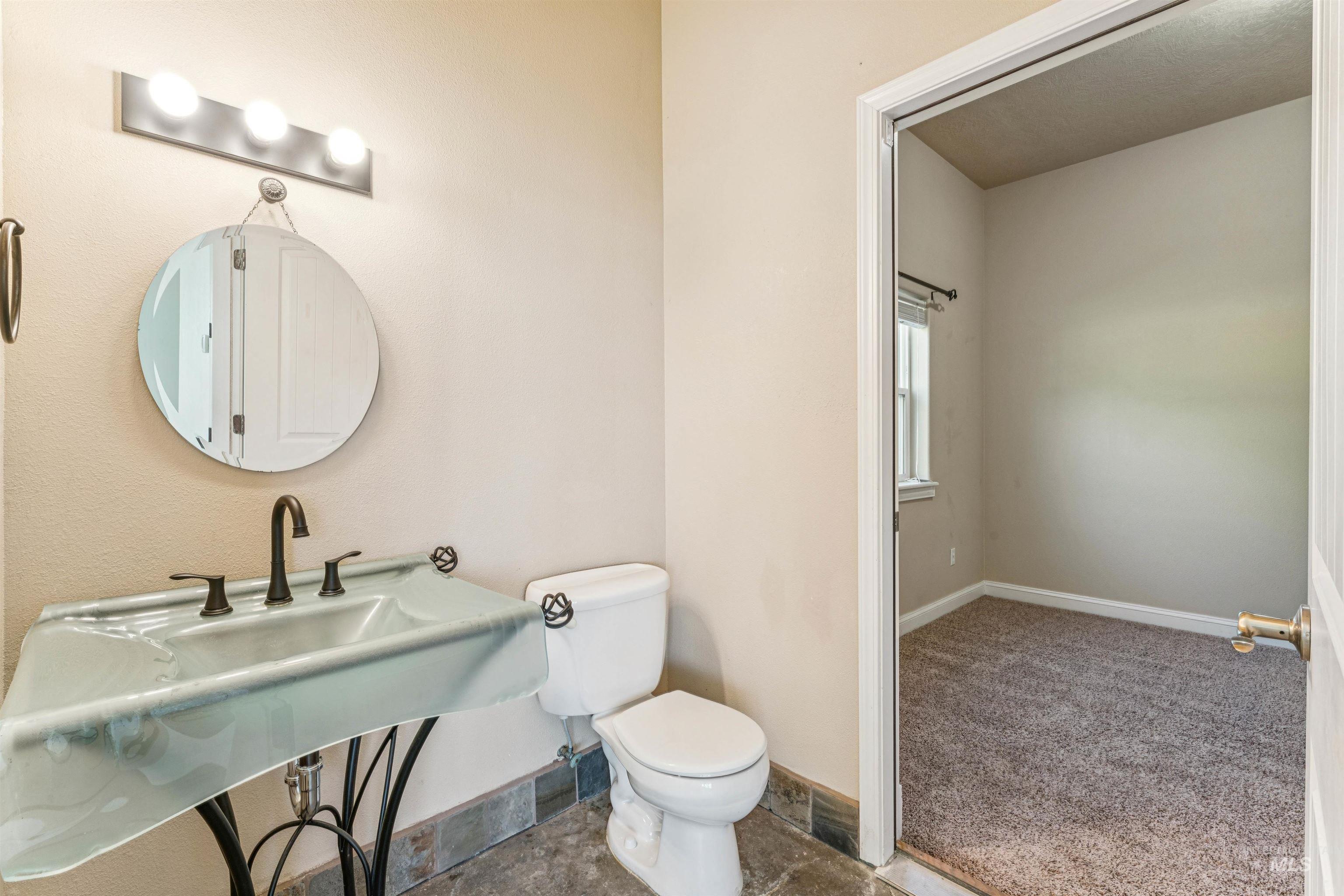 Half bath with toilet and baseboards