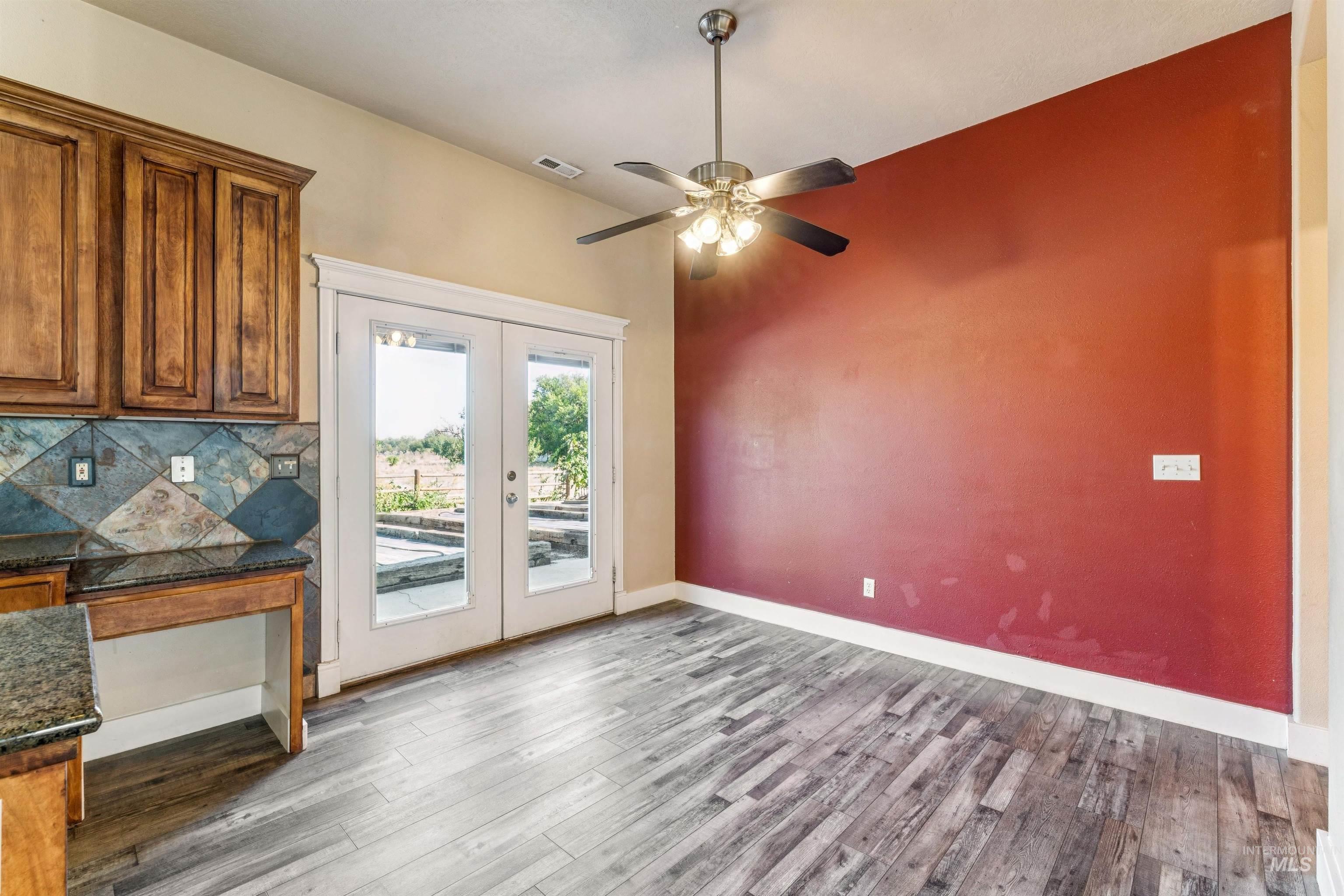 Entryway with wood finished floors, french doors, and ceiling fan
