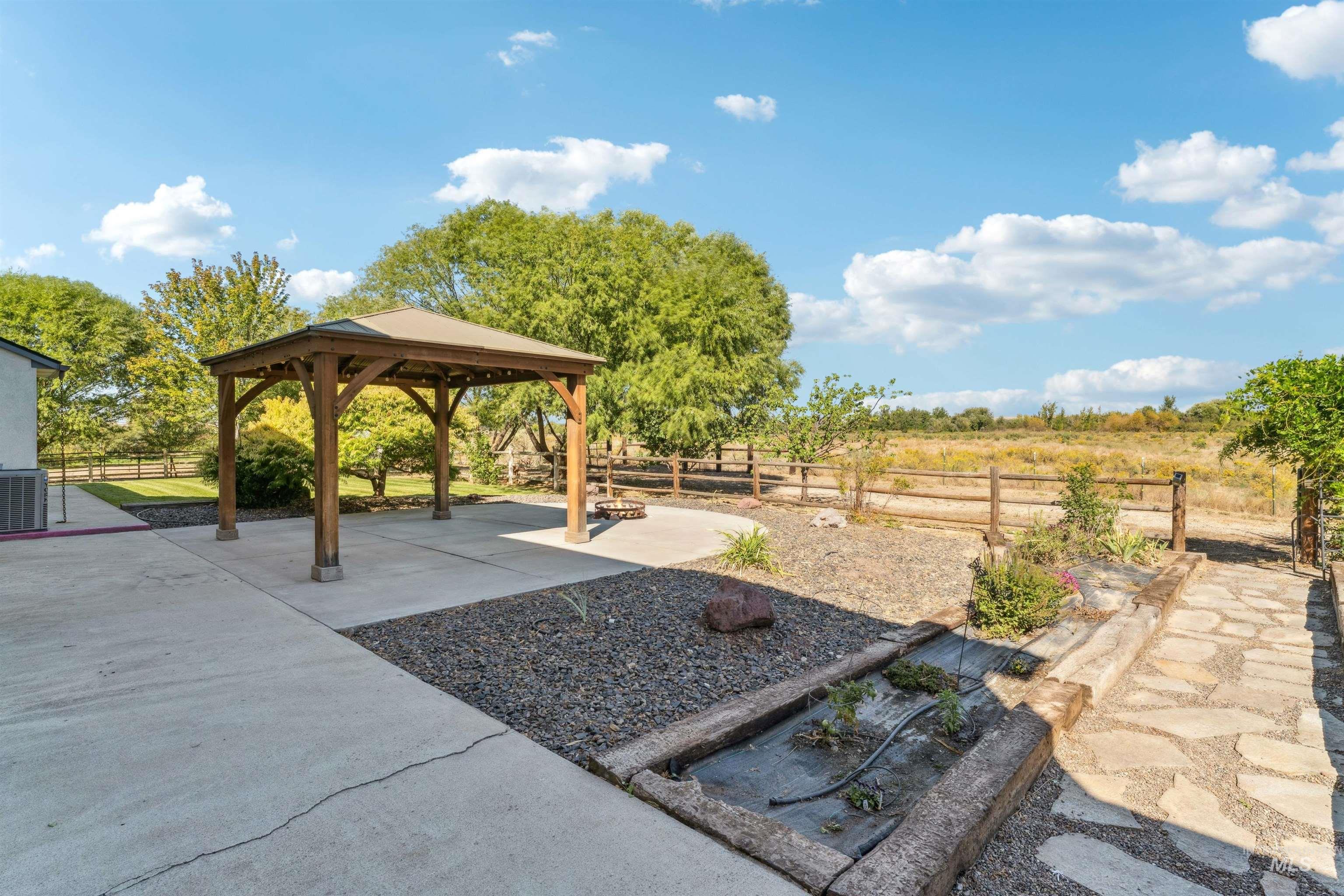 Fenced backyard with a patio area and a gazebo