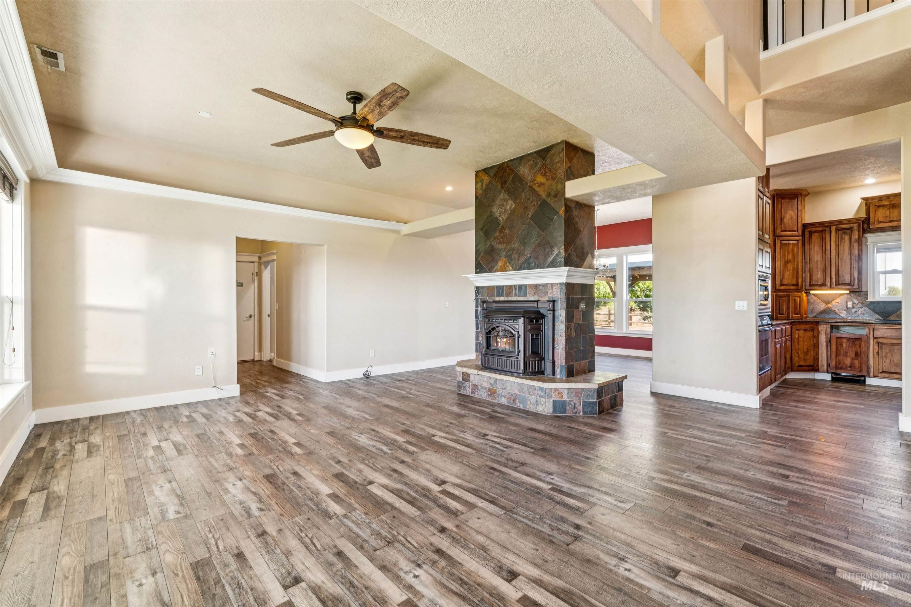 Unfurnished living room with ceiling fan, dark wood-type flooring, and recessed lighting