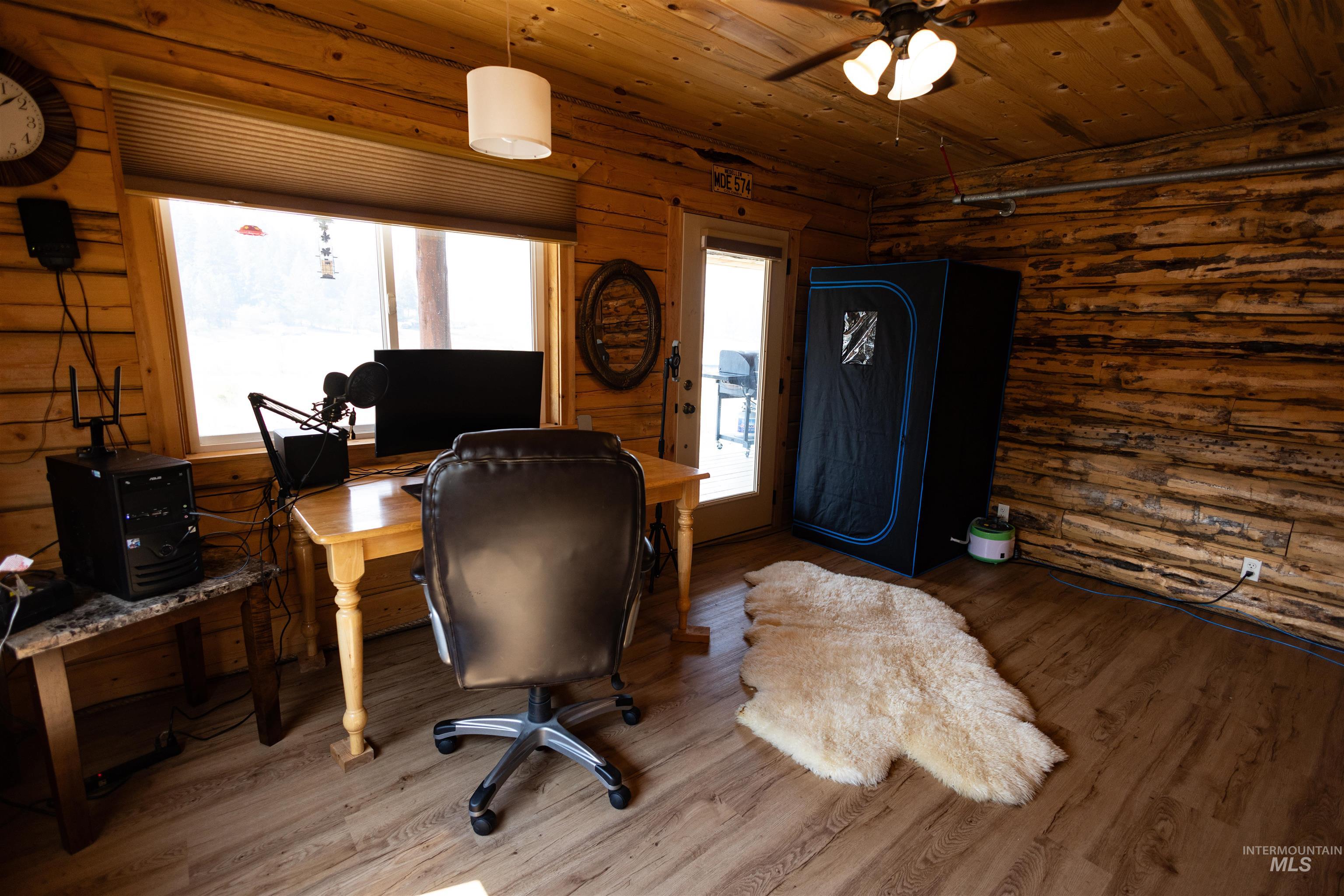 Office area featuring wooden ceiling, wood finished floors, and a ceiling fan
