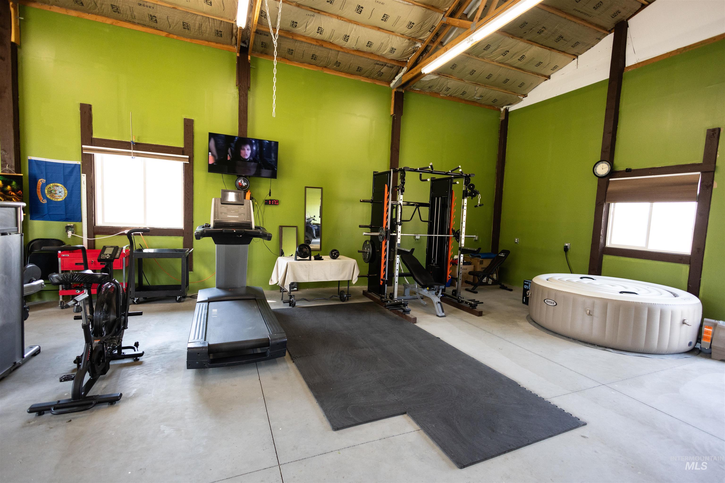 Workout area featuring healthy amount of natural light and a high ceiling