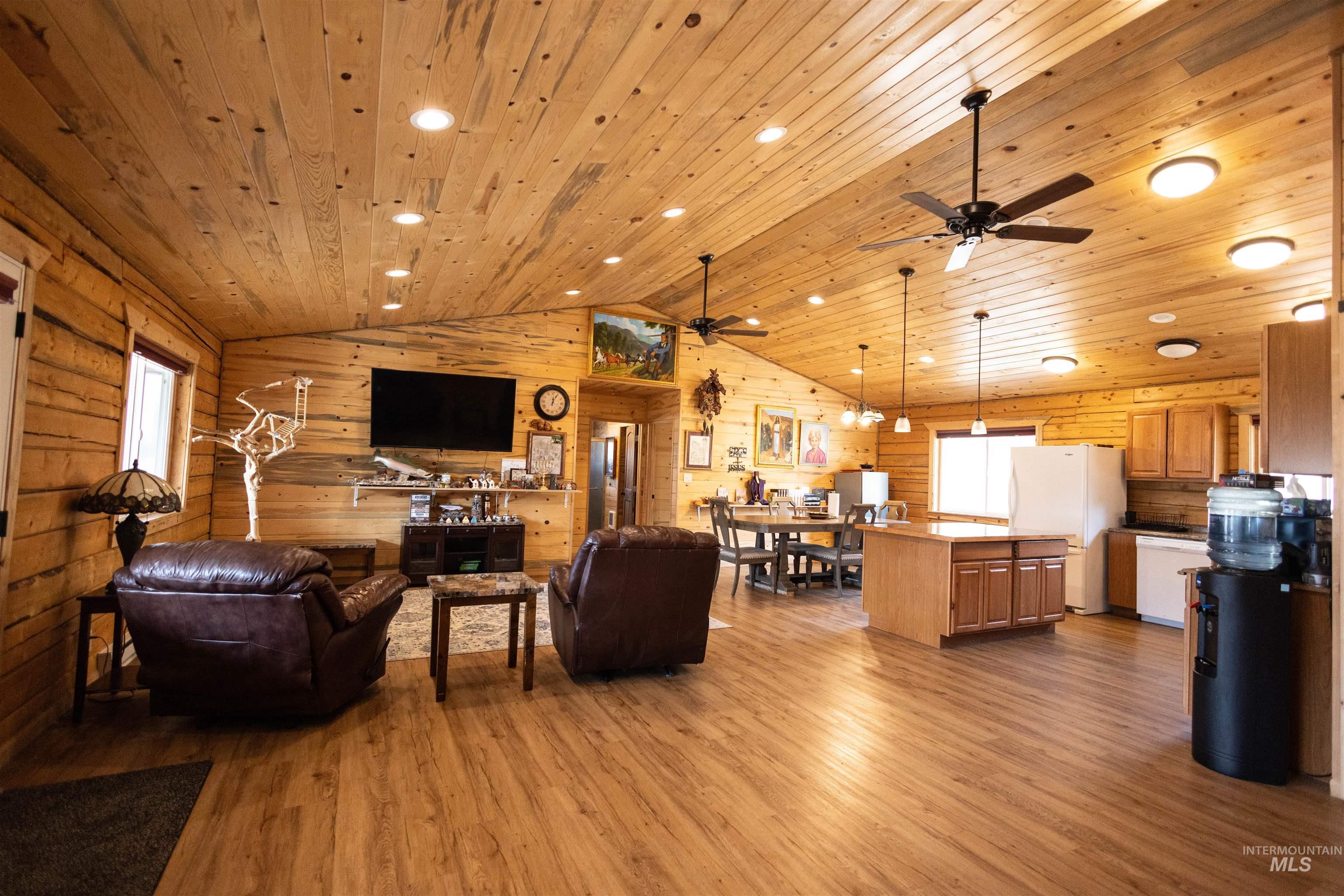 Living area with light wood-style floors, lofted ceiling, ceiling fan, recessed lighting, and wood ceiling