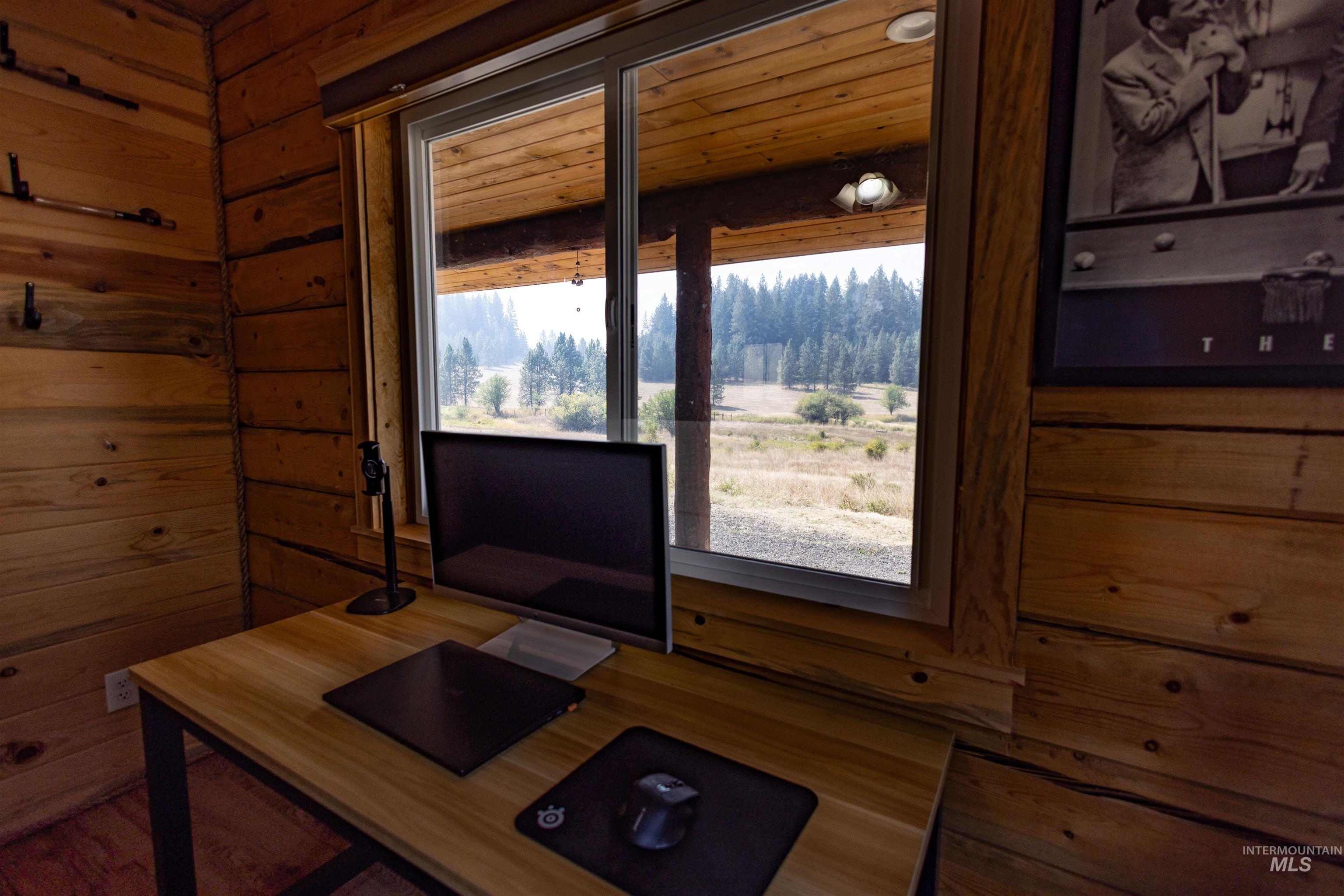 Office space featuring wood walls and wood finished floors