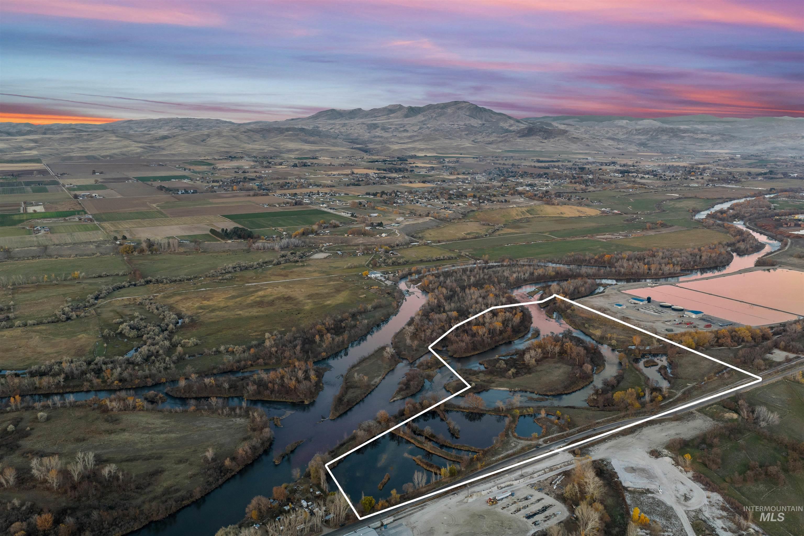 Aerial view at dusk of property parcel outlined and a mountain view