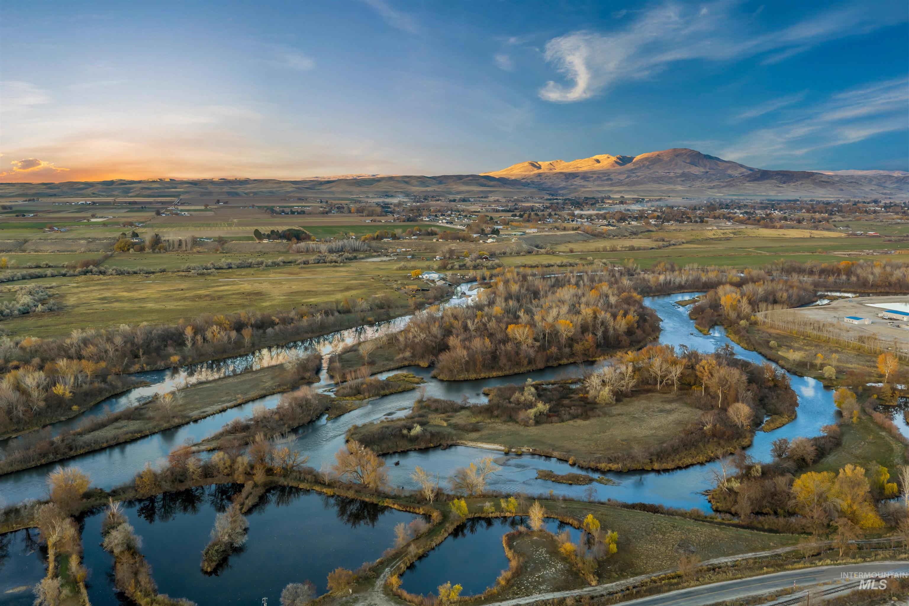 Aerial view of property and surrounding area featuring a nearby body of water