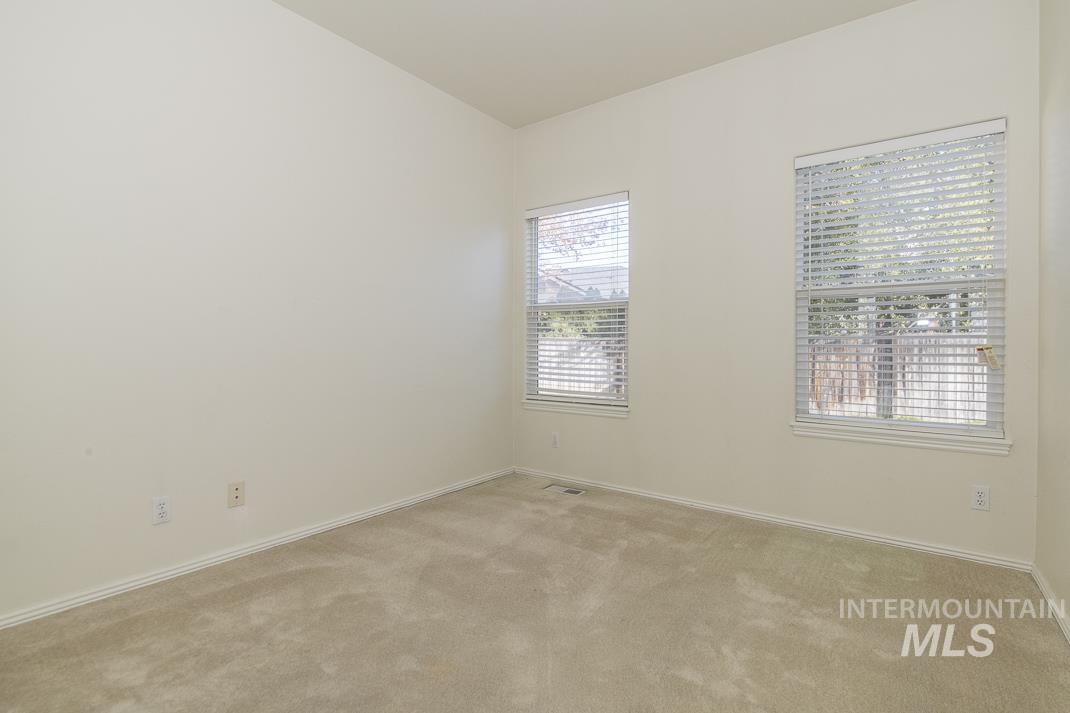 Unfurnished room with light colored carpet and baseboards