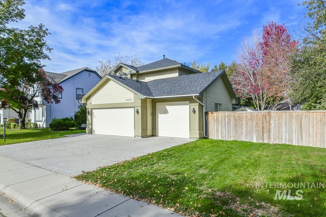 View of property exterior with a garage, concrete driveway, and roof with shingles