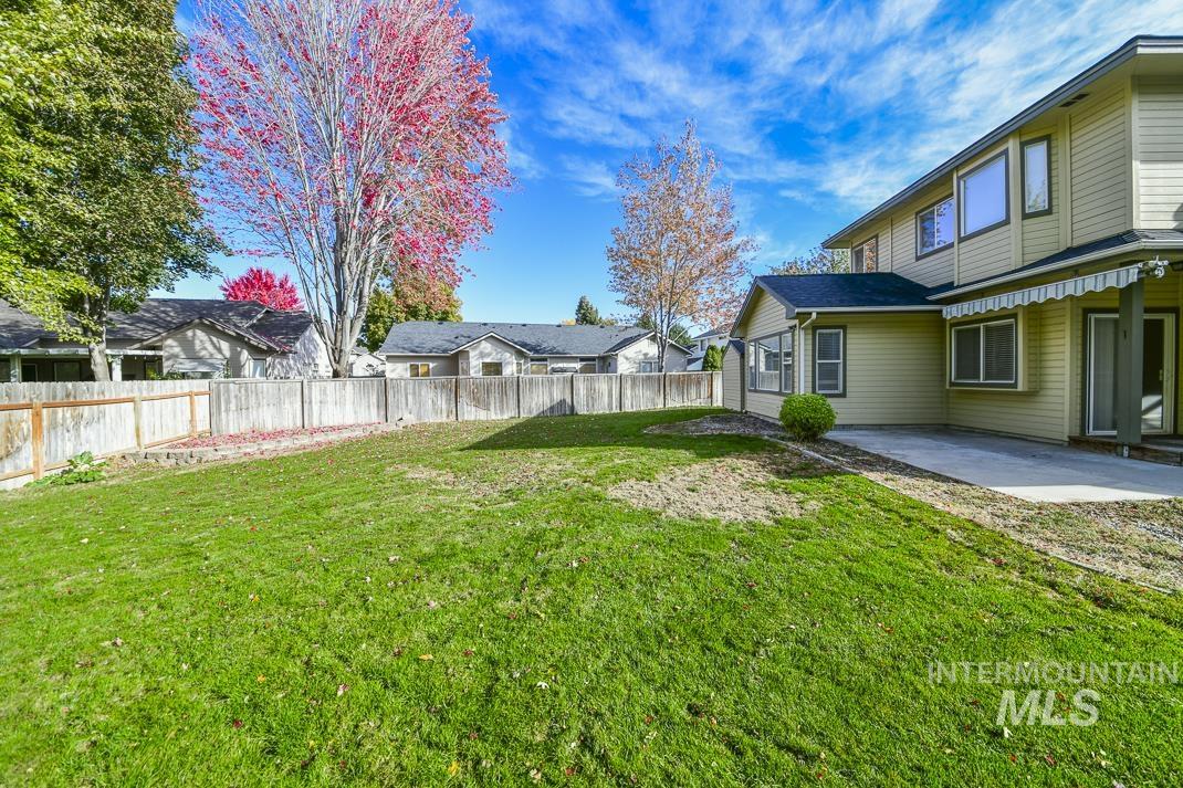 Fenced backyard with a patio and a residential view