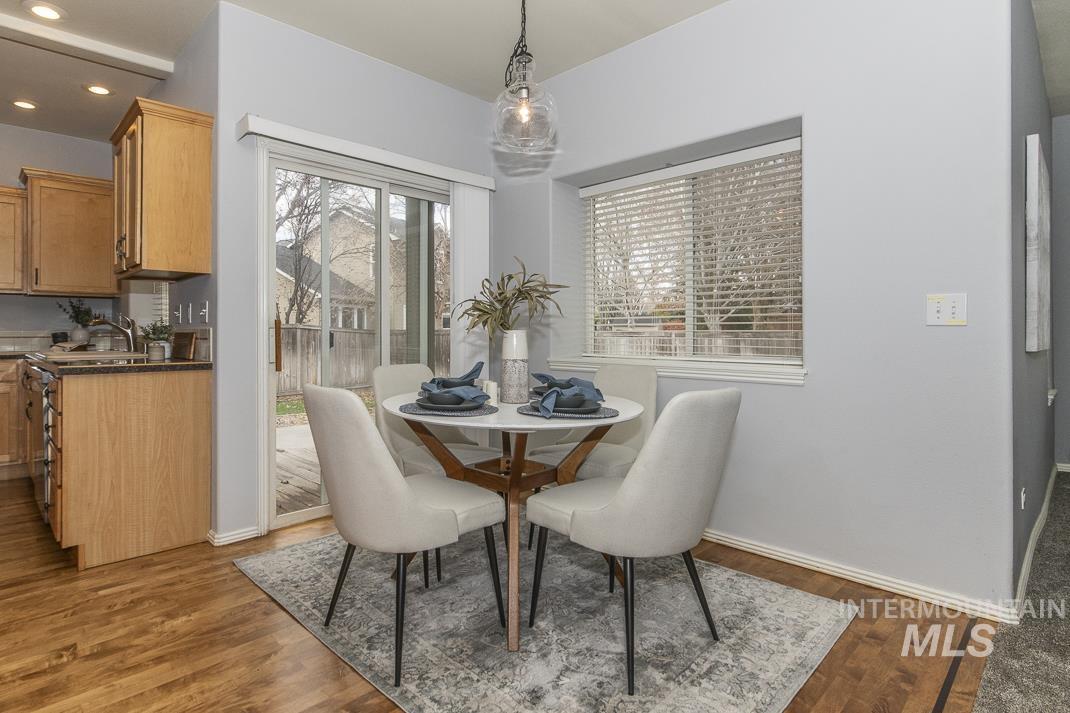 Dining room with healthy amount of natural light, dark wood finished floors, and recessed lighting