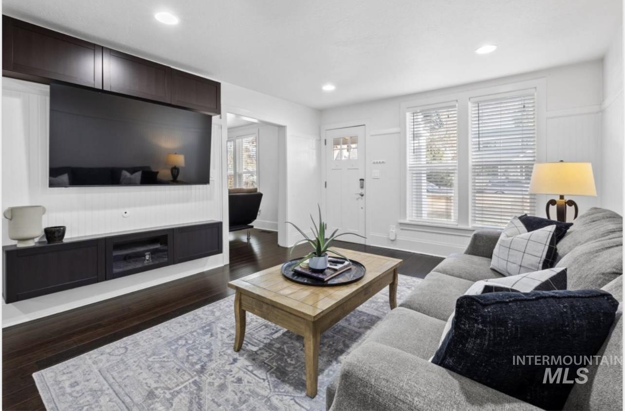 Living room with dark wood-style floors and recessed lighting
