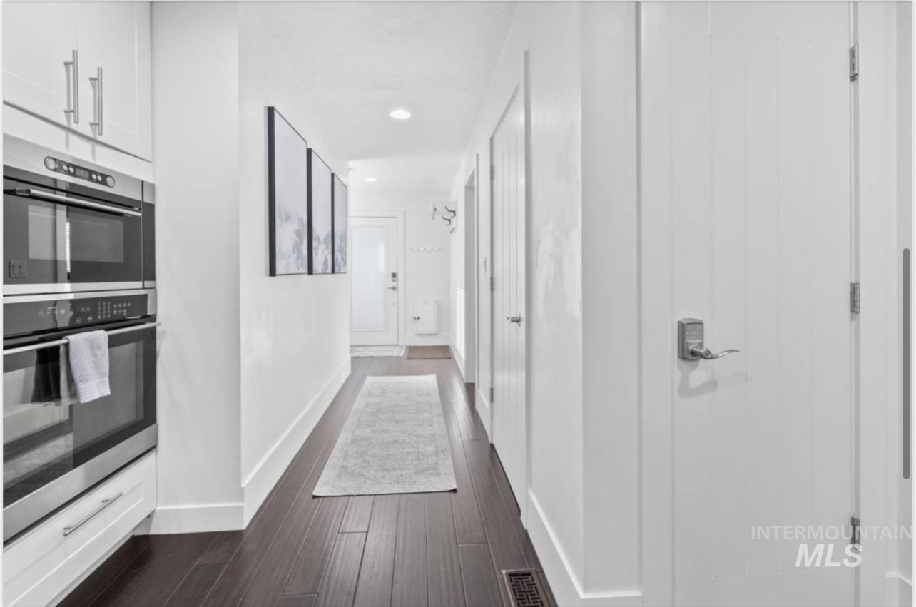 Hallway featuring dark wood-type flooring and recessed lighting