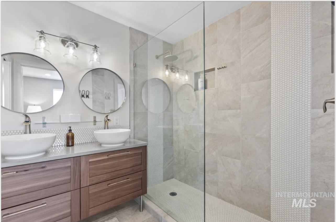 Bathroom featuring double vanity and walk in shower