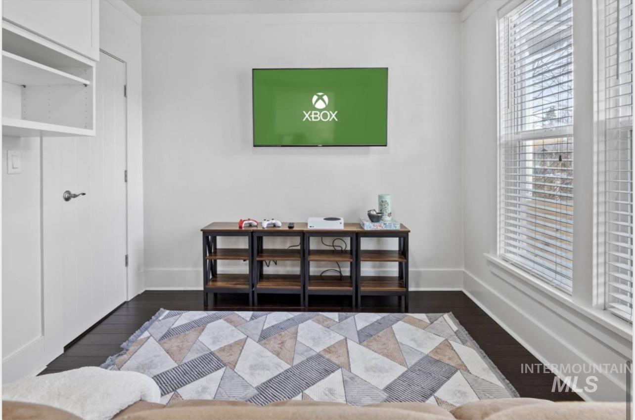 Entryway featuring dark wood finished floors and baseboards