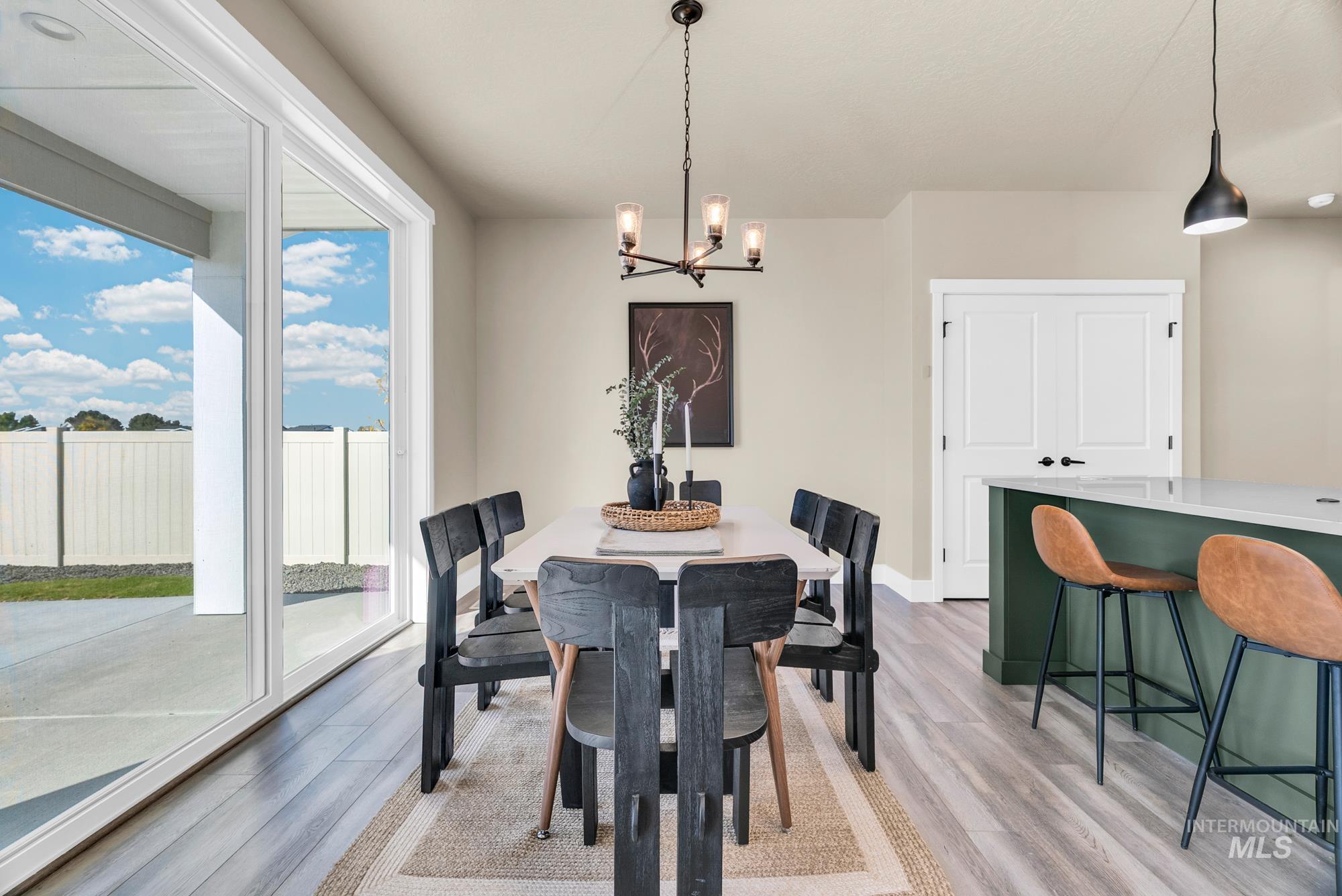 Dining area featuring a chandelier and light wood-style flooring