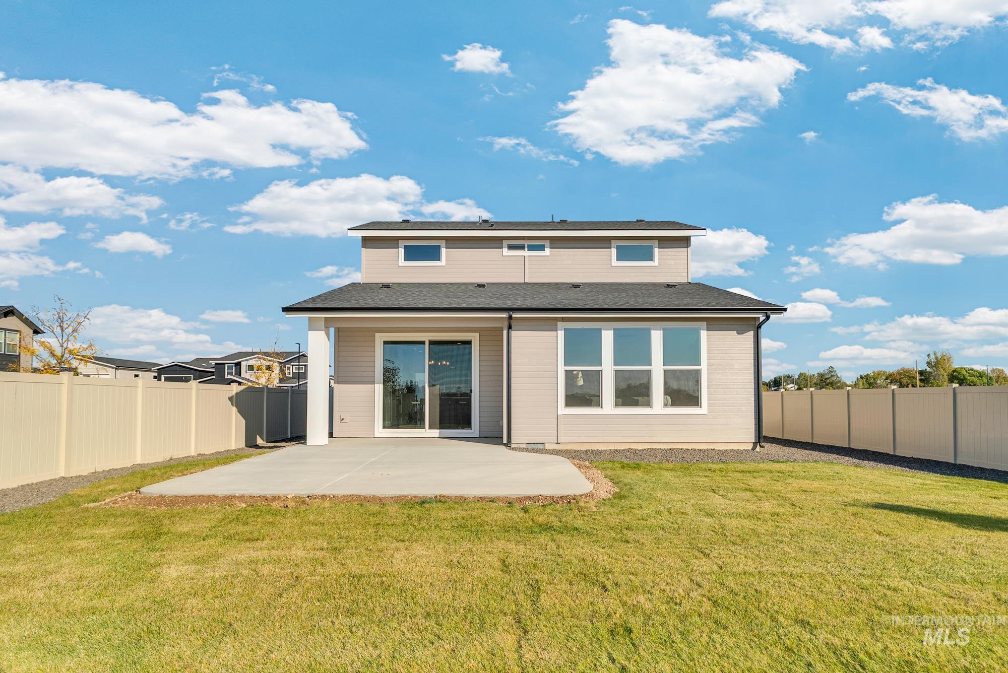 Rear view of property with a patio and a fenced backyard
