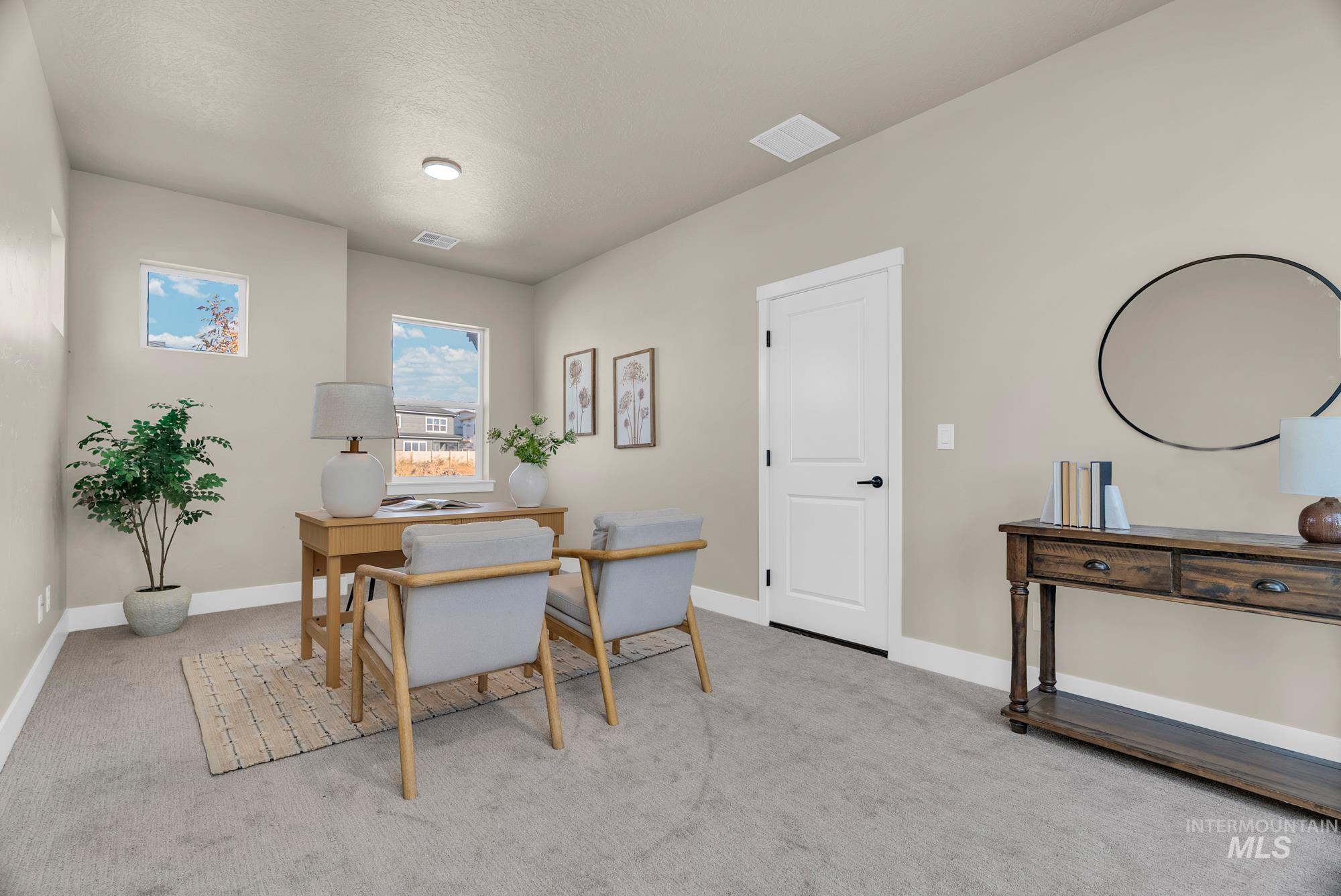 Dining space featuring an office area, carpet floors, and a textured ceiling