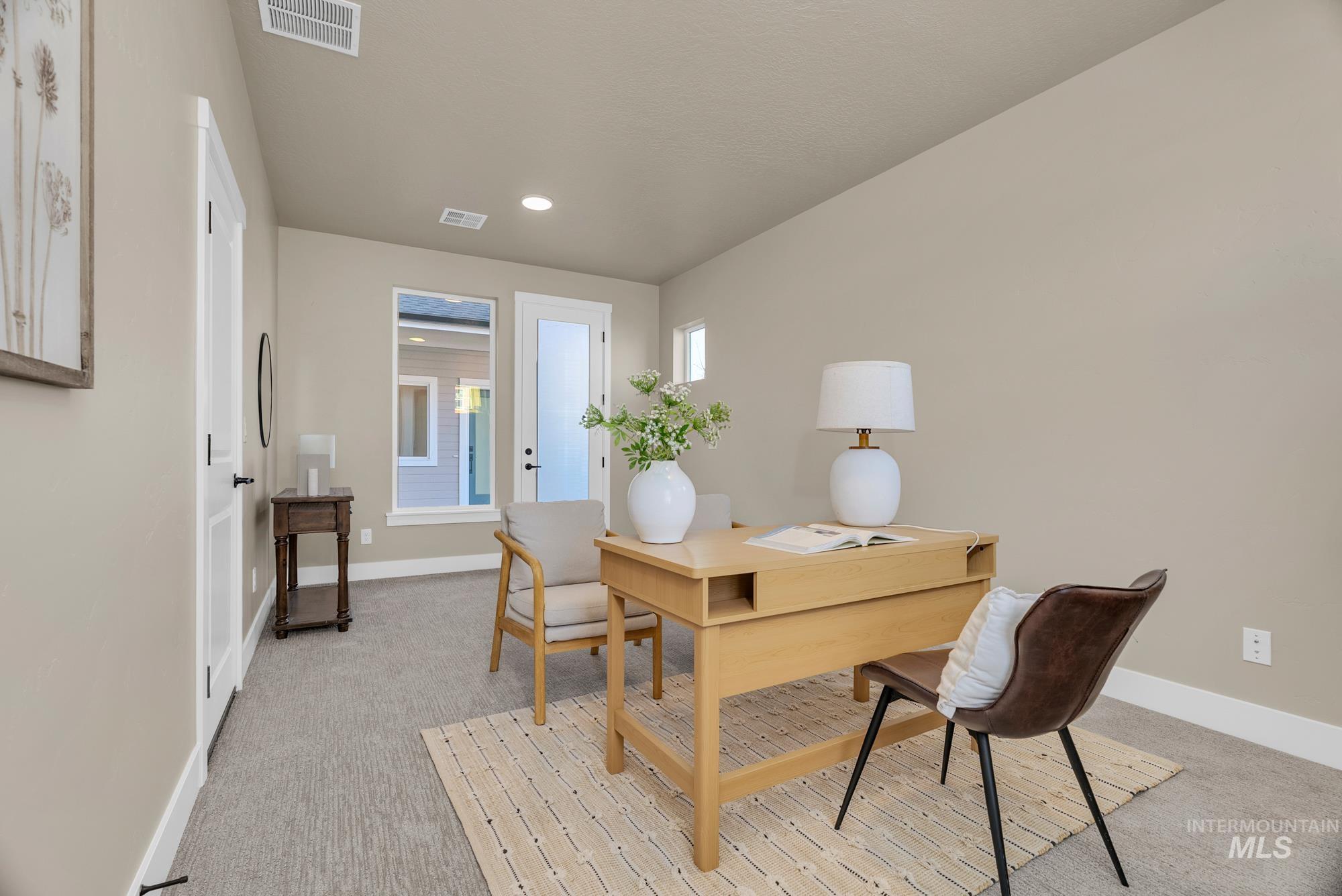 Office space featuring light carpet and recessed lighting