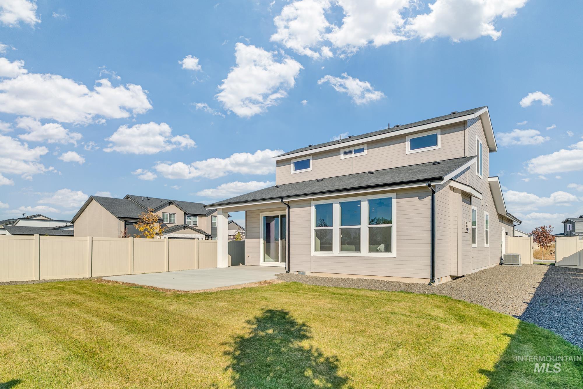 Back of property featuring a patio and a fenced backyard