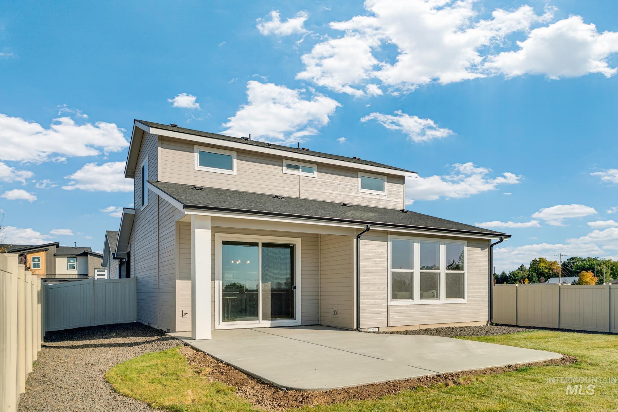 Back of house with a fenced backyard, a patio area, and a shingled roof