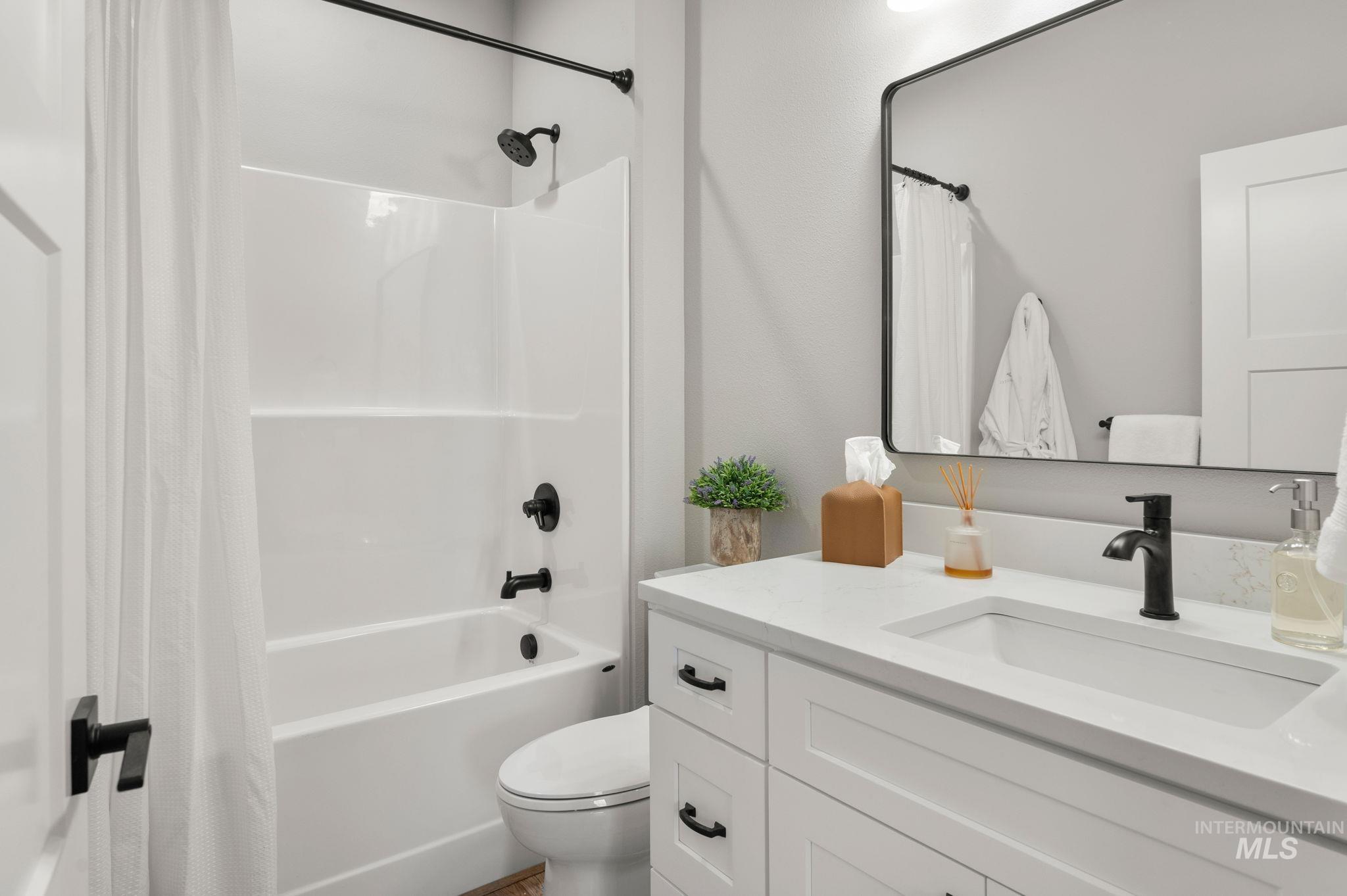 Full bathroom featuring shower / bath combo and vanity