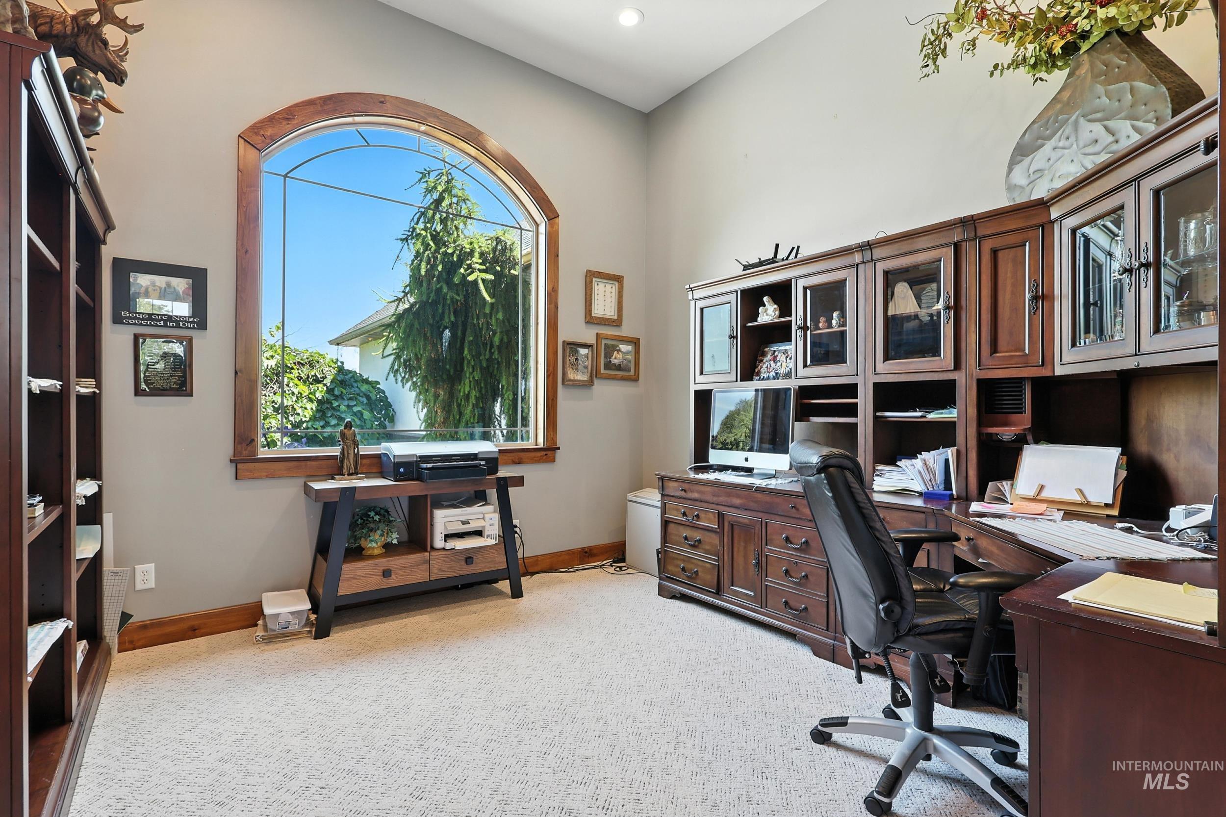 Office area with light carpet and recessed lighting