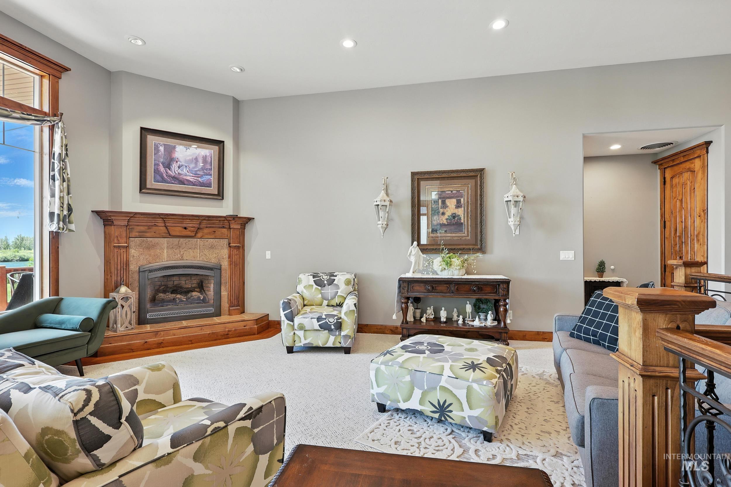 Living room with recessed lighting, carpet floors, and a fireplace