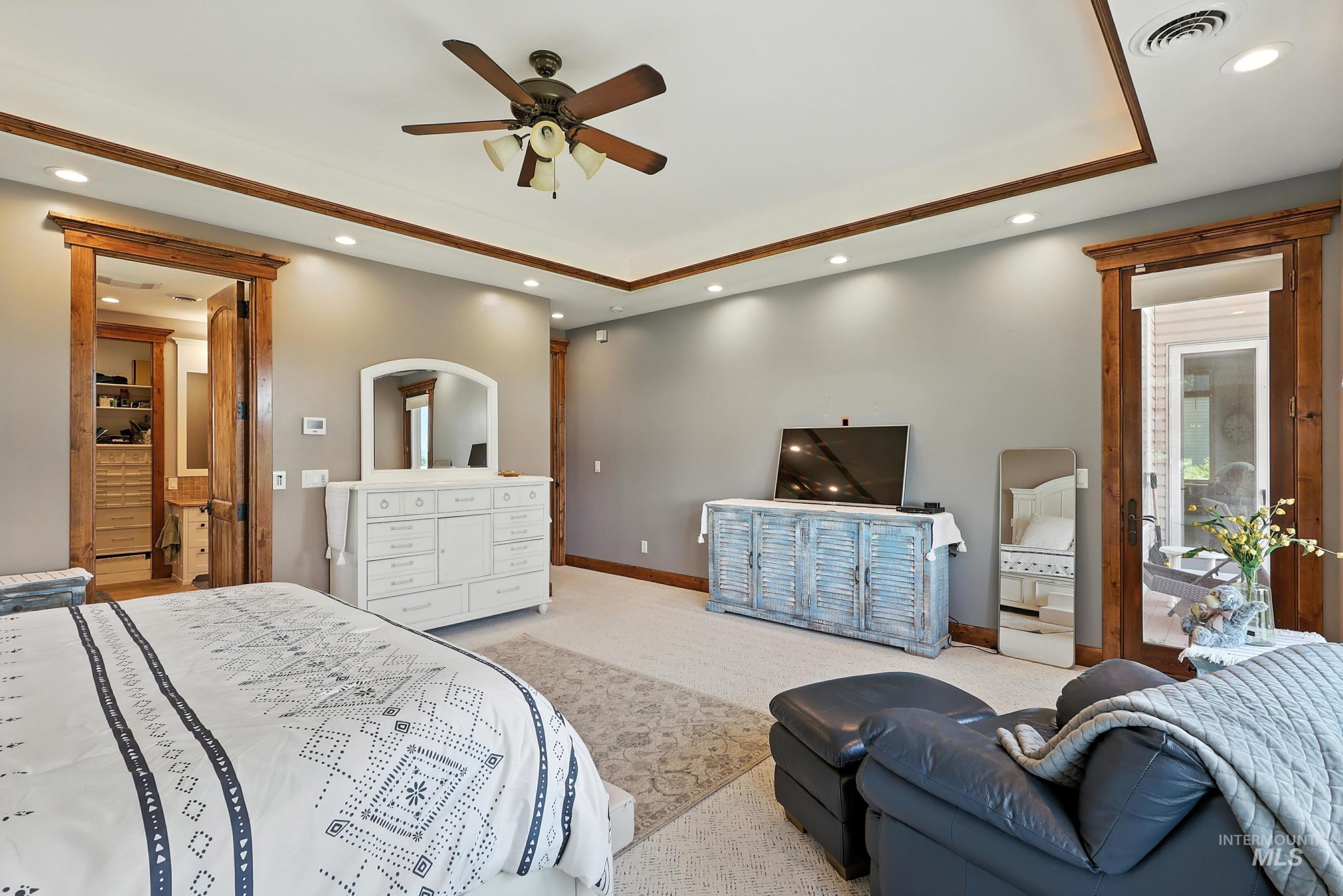 Bedroom with carpet flooring, recessed lighting, a tray ceiling, and ceiling fan