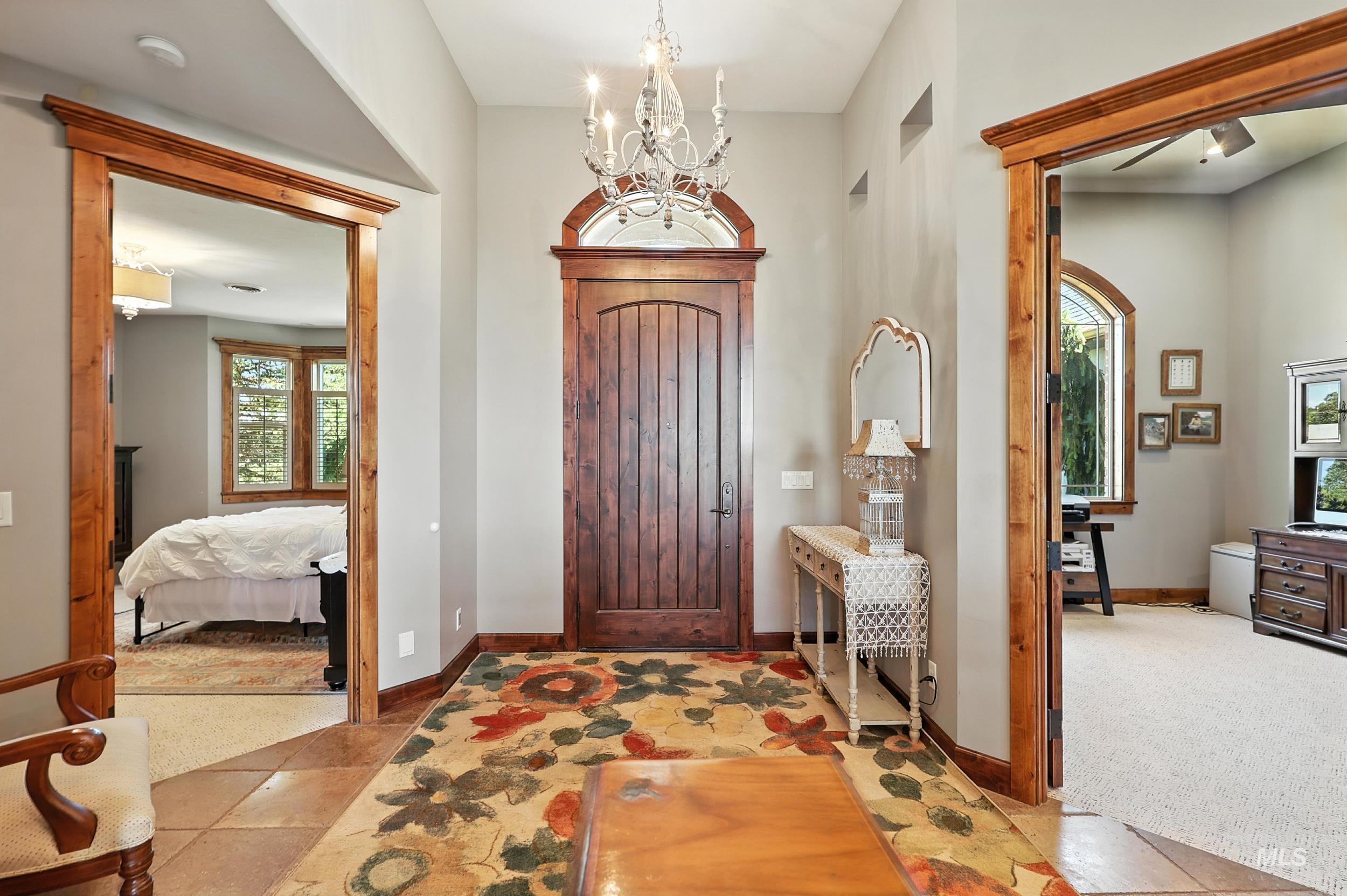 Foyer featuring a chandelier and light tile patterned floors