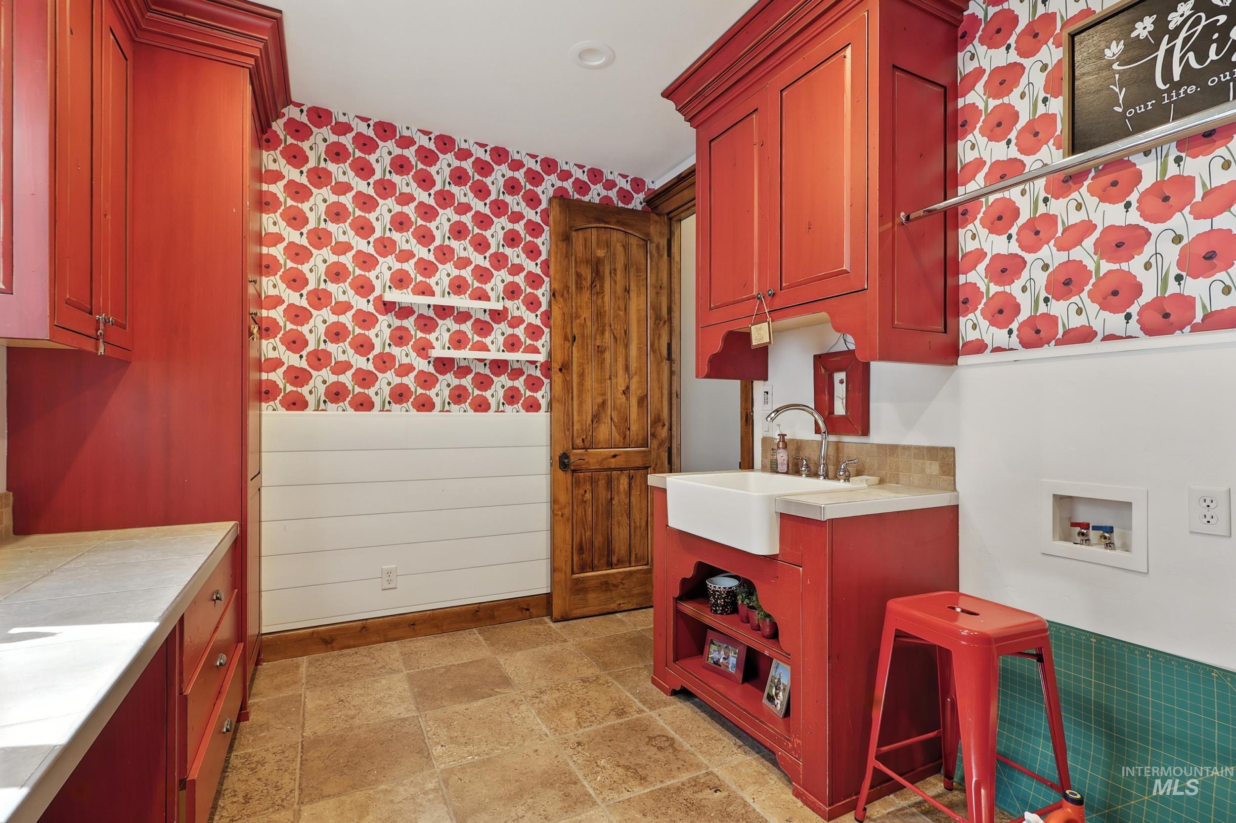 Washroom featuring wainscoting, wallpapered walls, and washer hookup