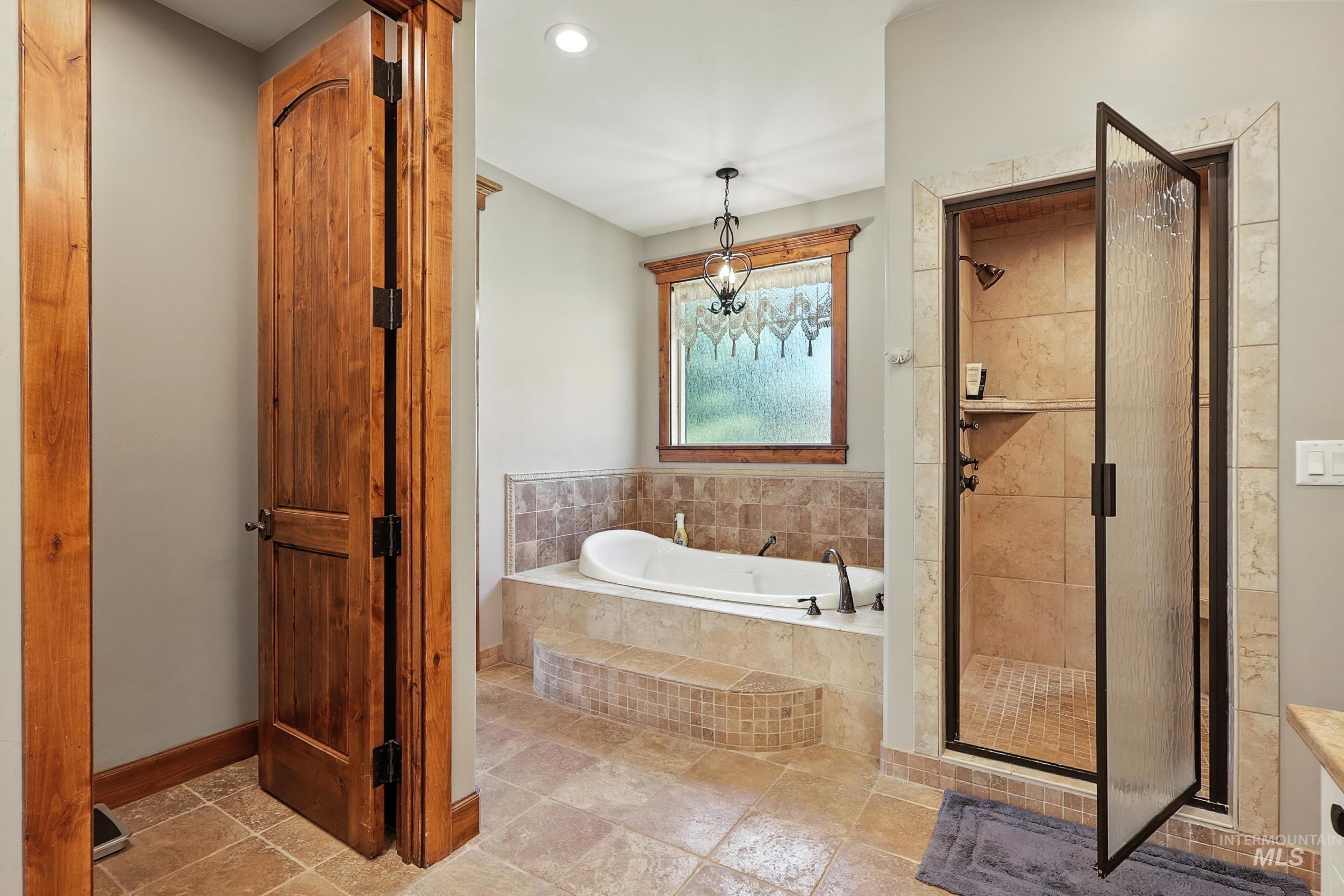Bathroom with a shower stall, a garden tub, and recessed lighting