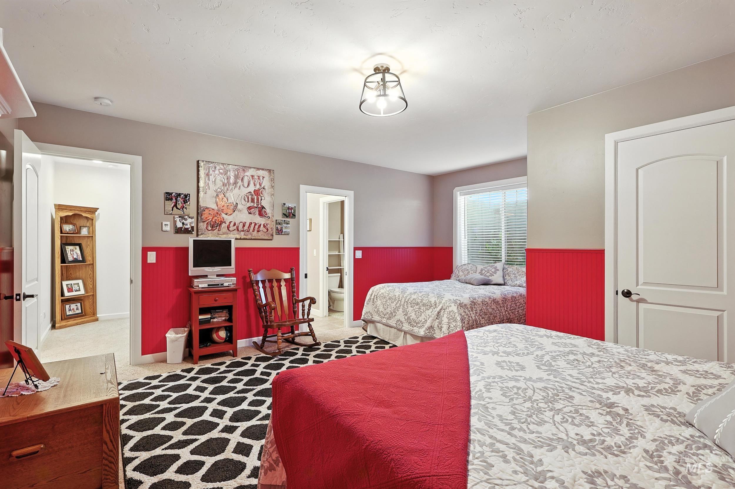 Carpeted bedroom with ensuite bathroom
