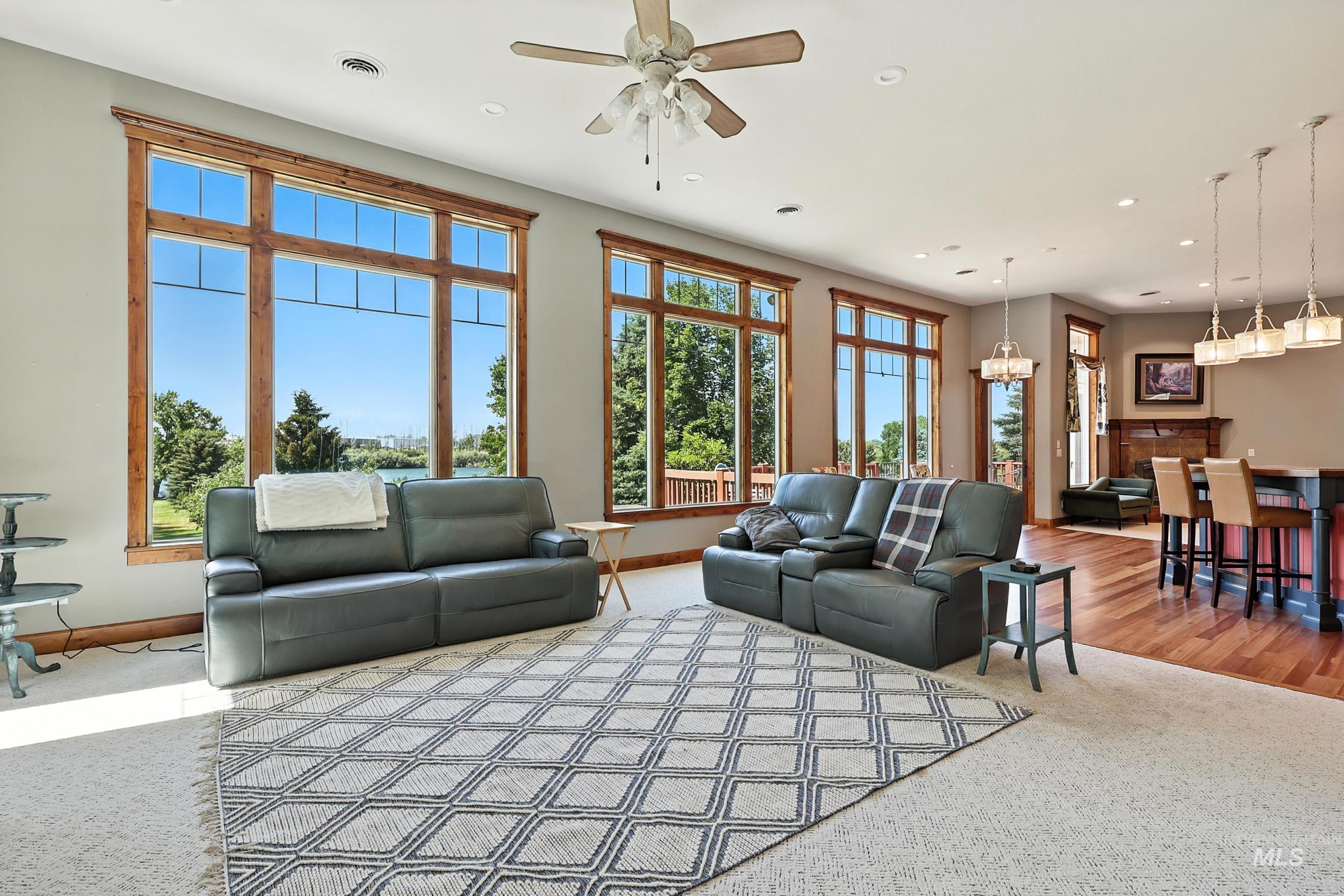 Carpeted living room with recessed lighting and a ceiling fan