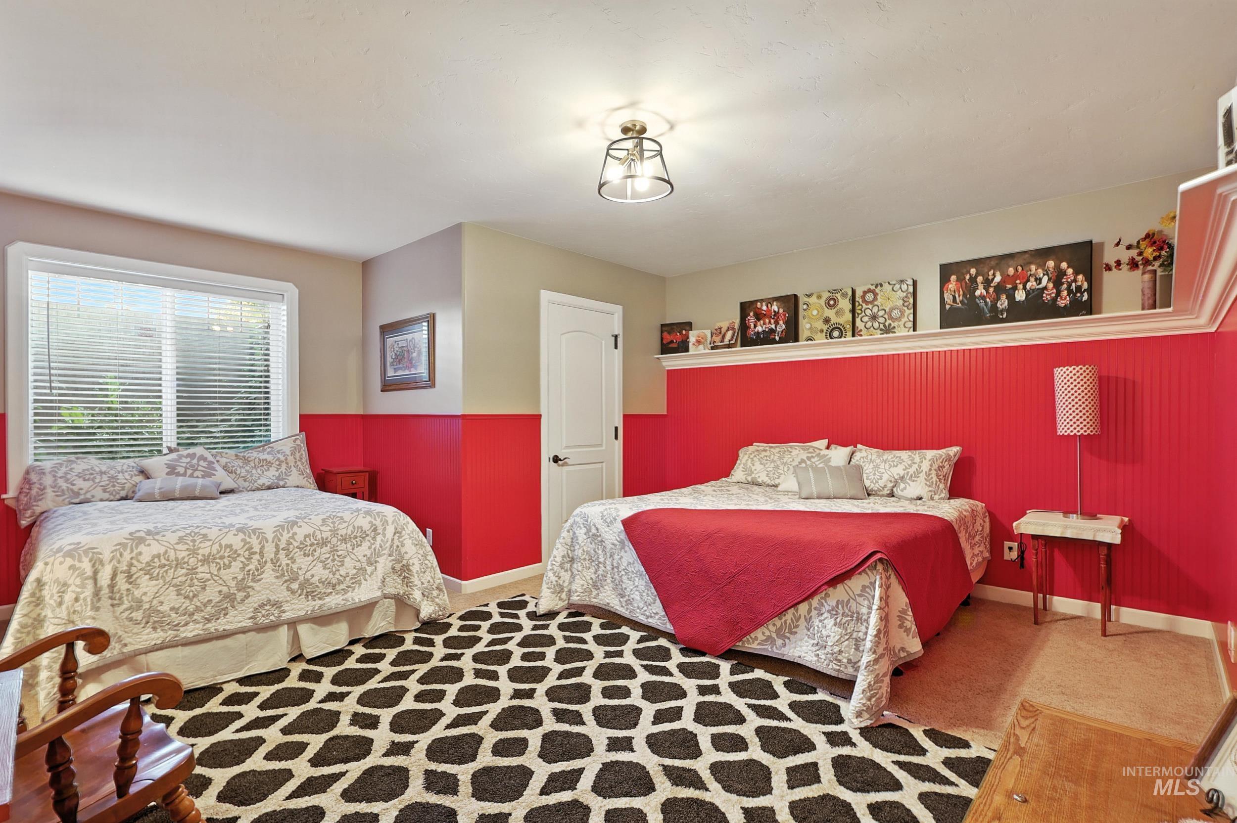 Bedroom featuring carpet flooring and baseboards