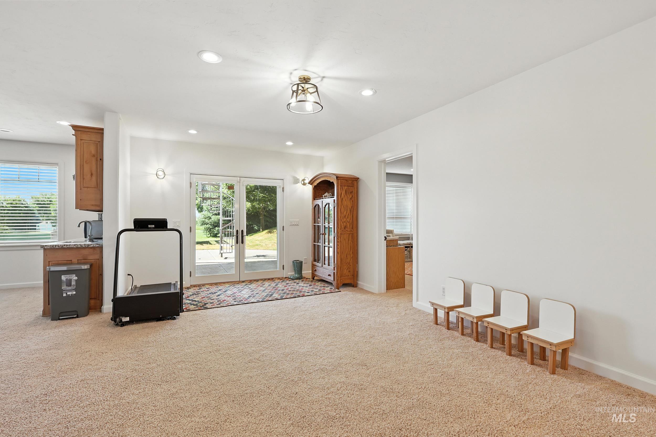 Workout room with french doors, light carpet, and recessed lighting
