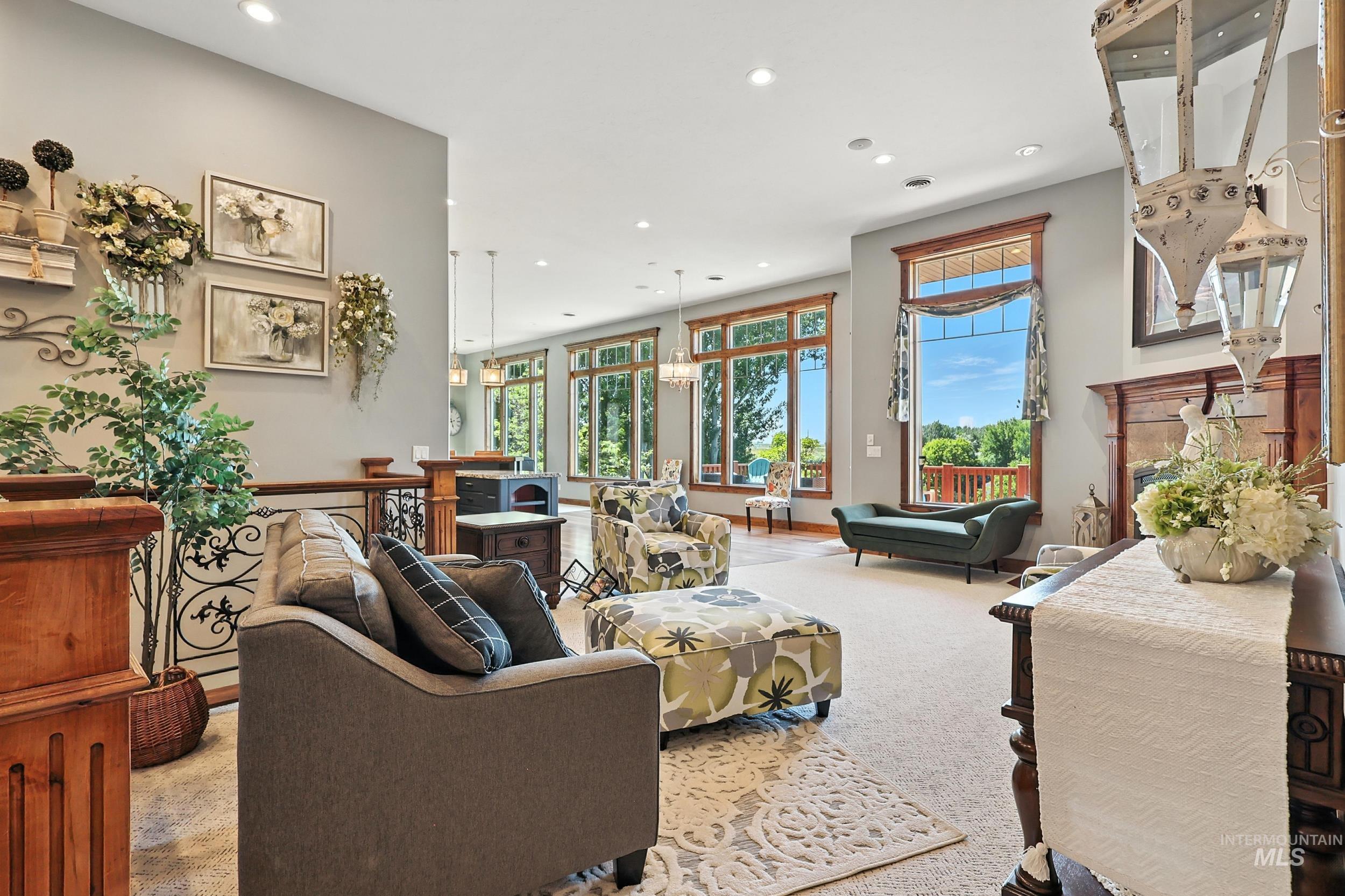 Living area with carpet flooring, recessed lighting, and a fireplace