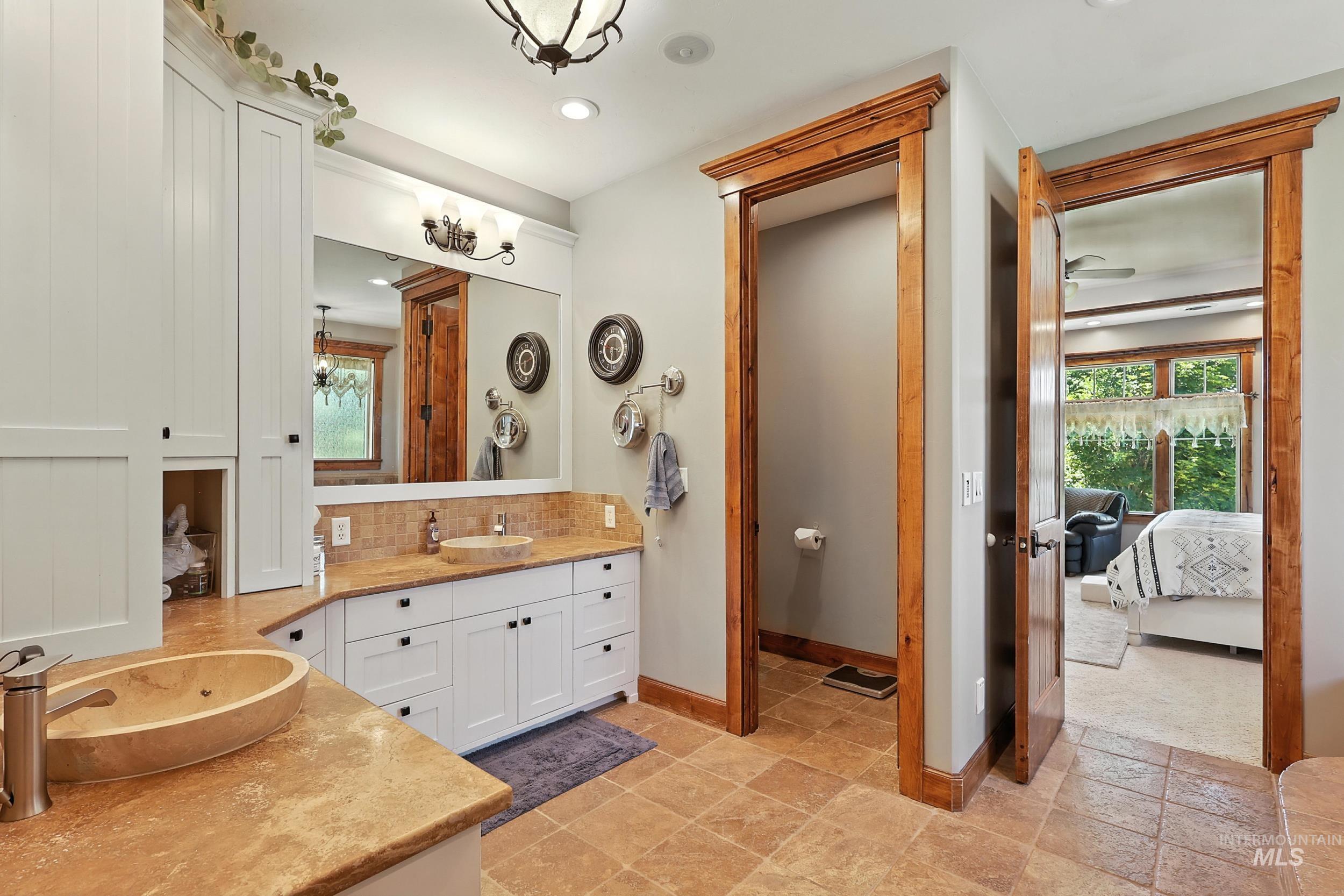 Full bathroom with vanity, connected bathroom, decorative backsplash, and recessed lighting