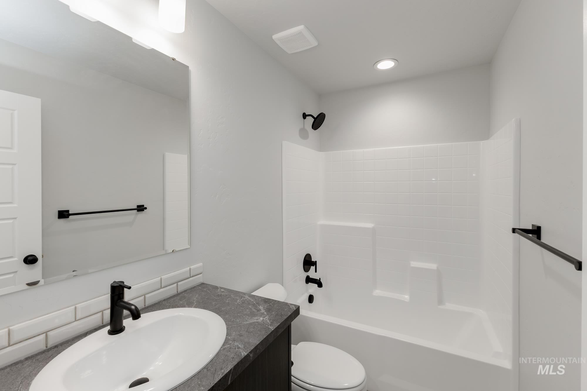 Full bathroom with vanity and bathtub / shower combination
