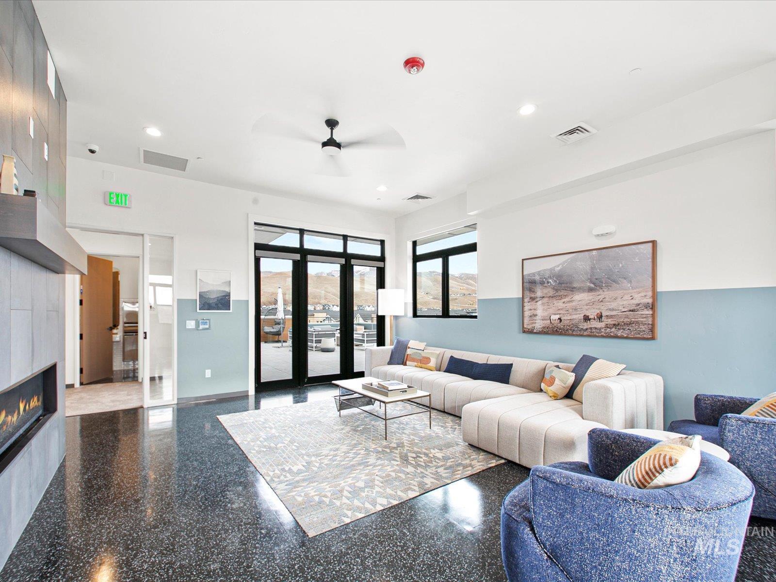 Living area with a fireplace, a ceiling fan, and recessed lighting
